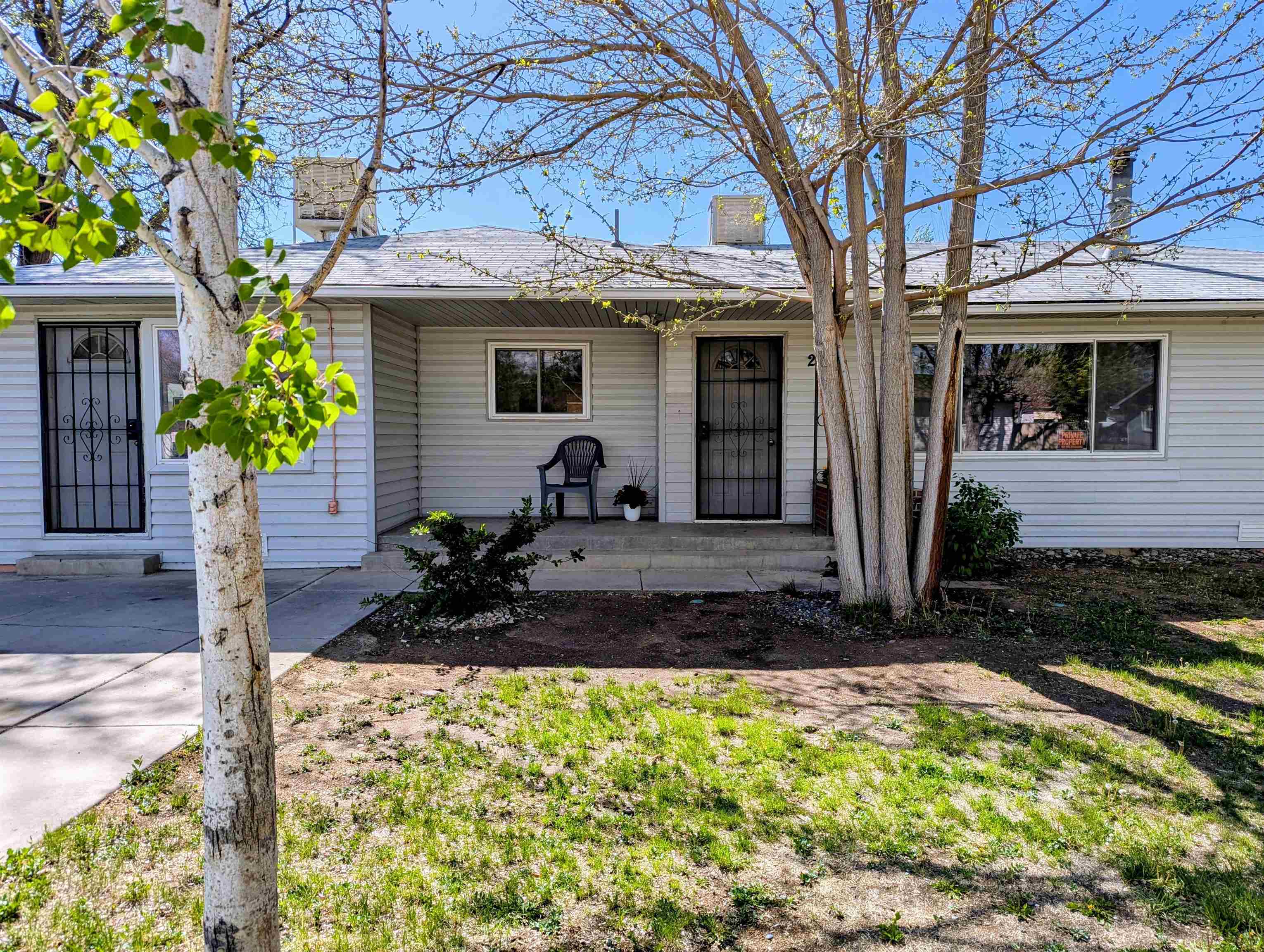 This charming home features stunning hardwood floors throughout, highlighted by a spacious living room adorned with a large picture window. The generously sized bedrooms offer ample comfort, complemented by a convenient built-in linen closet in the hallway. Ample vehicle parking, including a large RV parking area, ensures convenience for all residents. The expansive yard boasts three storage sheds, while a versatile workroom presents an ideal space for various activities, complete with a potential bar area and plumbing.