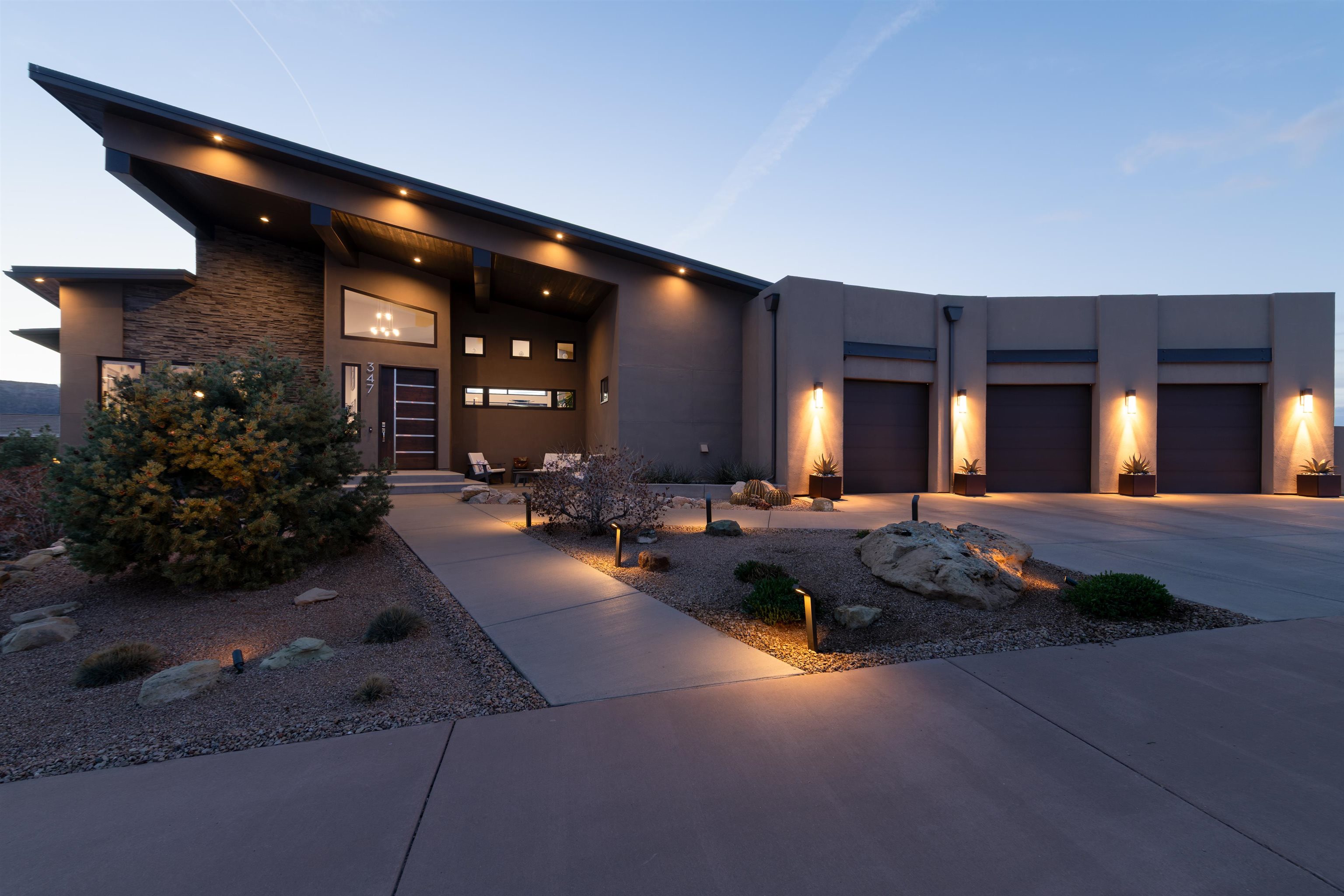 Welcome to this stunning mountain modern ranch style residence with walk-out basement overlooking the iconic 18th hole of Redlands Mesa Golf Course. Take in the spectacular views from the upper and lower covered patios all while enjoying the outdoor kitchen, fire pit and hot tub.  A beautiful water feature graces the front of the home, adding to the serene ambiance. Step inside to find an open concept living space with 16' ceilings, a cozy fireplace and a wall of windows offering tons of natural light. The contemporary kitchen boasts custom cabinetry, a large island and a hidden pantry for a plethora of storage. The main level primary suite is complete with a generously sized custom closet and large walk-in shower. Finishing out the main level are a functional laundry area/mud room, junior suite with a private bathroom, half bathroom and access to the oversized 3 car garage. Head down the wide staircase to find a family room with dry bar, 2 bedrooms with adjoining bathroom and an additional bedroom that doubles as an office. With its ideal location, luxurious amenities including smart home features and owned solar, and picturesque views, this property is perfect for those seeking an exceptional lifestyle. Schedule your private tour today!