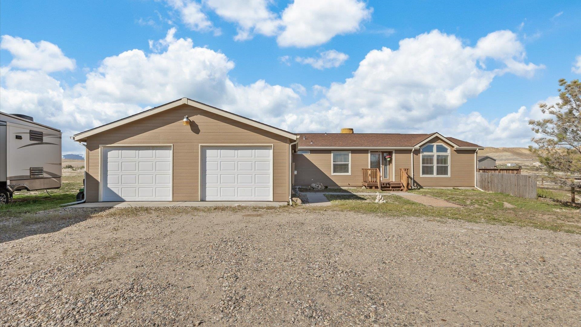 Escape to the country with this spacious 2537 square foot home nestled on nearly 6 acres of freedom! Imagine the possibilities... no HOA, plenty of space for all your toys (including 50 amp RV hookup and an oversized 2 car garage), animals, or whatever you choose to do! This gorgeous home has been immaculately maintained and features 2 living areas, a fireplace, wet bar perfect for entertaining, huge primary bedroom with a walk-in closet and bathroom with a soaker tub, and 2 decks to relax on and watch the sunset! Many updates include newer roof (2020), gutters (2022) paint, newer appliances, and vinyl plank flooring. The property has a ditch on the west side that regularly fills with run-off water from the neighboring property and could potentially be used for irrigation. Come see your new country escape today!