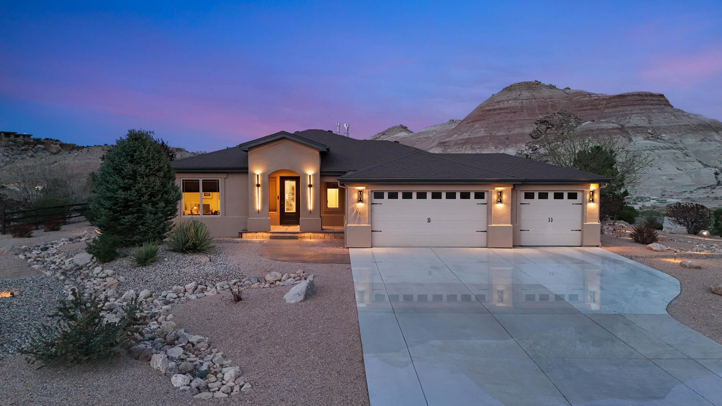 As beautiful and peaceful as its surroundings, this desert retreat offers the best of Colorado living. With sweeping 360-degree views and unbeatable access to the Lunch Loops trail system and Colorado National Monument, this home is a dream for outdoor enthusiasts — and it’s less than 10 minutes to downtown for shopping, groceries, and dining. Inside, you’ll be welcomed by an abundance of natural light pouring through floor-to-ceiling windows—professionally tinted with 99% UV protection to keep the interior cool and sun-safe year-round. The open-concept layout seamlessly connects the kitchen and living area in a bright, inviting space perfect for relaxing or entertaining. Tech-savvy touches are everywhere, including Lutron smart switches that allow you to control the 3K dimmable lighting throughout the home and garage right from your phone. The home features 2 spacious bedrooms and 2 bathrooms, including a generous primary suite with a luxurious 5-piece ensuite bath, a relaxing soaker tub, and a large walk-in closet. Set on a professionally xeriscaped half-acre lot, the outdoor living space is just as thoughtfully designed. Enjoy peaceful evenings on the back patio, or gear up for your next adventure in the oversized three-car garage—complete with a mini split system for heat and A/C, and a pull-down screen door, perfect for storing your outdoor gear or creating a flexible workspace. Whether you’re chasing adventure or just want a quiet place to unwind, this home delivers!