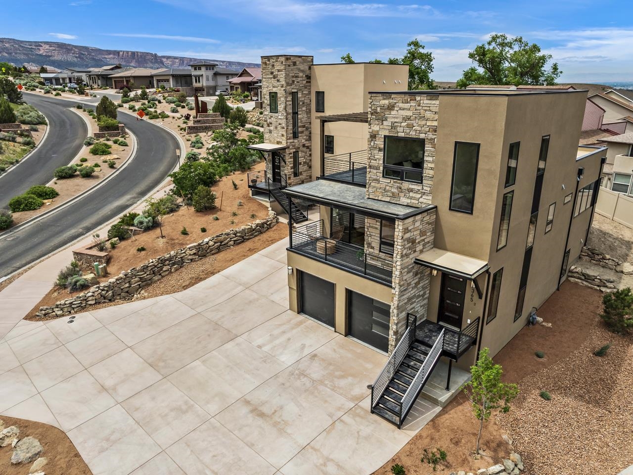 Welcome to the epitome of luxurious low-maintenance living in the vibrant Redlands area of Grand Junction, CO. Situated in the heart of this highly sought-after neighborhood in the new Casas de Luz Development, discover these newly constructed townhomes that embody elegance and sophistication. Created with meticulous attention to detail by renowned builder John Bennett of Canyon Vista Homes, these modern desert homes offer a sustainable and upscale living experience designed with community in mind. When finished, the project will include 8 townhomes and 6 condominiums, beautiful desert landscaping and water features, and plenty of parking. This home has an impressive layout, featuring 4 bedrooms, 3 ½ baths, and ample room for all your needs. With two distinct living spaces, you'll have plenty of room to entertain guests or create cozy retreats for relaxation. Unwind on one of the two balconies, perfectly positioned to capture breathtaking views of the Colorado National Monument, the Grand Mesa, and the picturesque Redlands Mesa Golf Course. The attached 2-car garage is oversized, providing generous parking space and additional storage for all your outdoor gear and belongings. The main floor living area is an open and luminous space with amazing natural light, courtesy of large windows that showcase the surrounding landscapes. The kitchen is a true culinary haven, featuring a beautiful design with ample storage and counter space. Stainless steel appliances add a touch of modern elegance, while a convenient dry bar allows for effortless entertaining. Seamlessly transitioning to the main floor balcony, you can revel in the joys of indoor-outdoor desert living. Additionally, the main floor encompasses two bedrooms, one of which has a private door leading to the 3/4 bath, and a large laundry room with abundant storage. An additional half bath is available for guests.  The entire upper level is dedicated to the primary suite, offering a private sanctuary with exclusive access to the upper balcony. Indulge in the luxurious 5-piece bath, complete with a soaking tub and walk-in shower. Downstairs, you'll find an additional bedroom, living area, and full bathroom, providing further space and versatility. Ask about potential layout modifications to customize this home to your specific needs! Near year Redlands trail systems and abundant recreational opportunities. Make this Redlands gem your own!