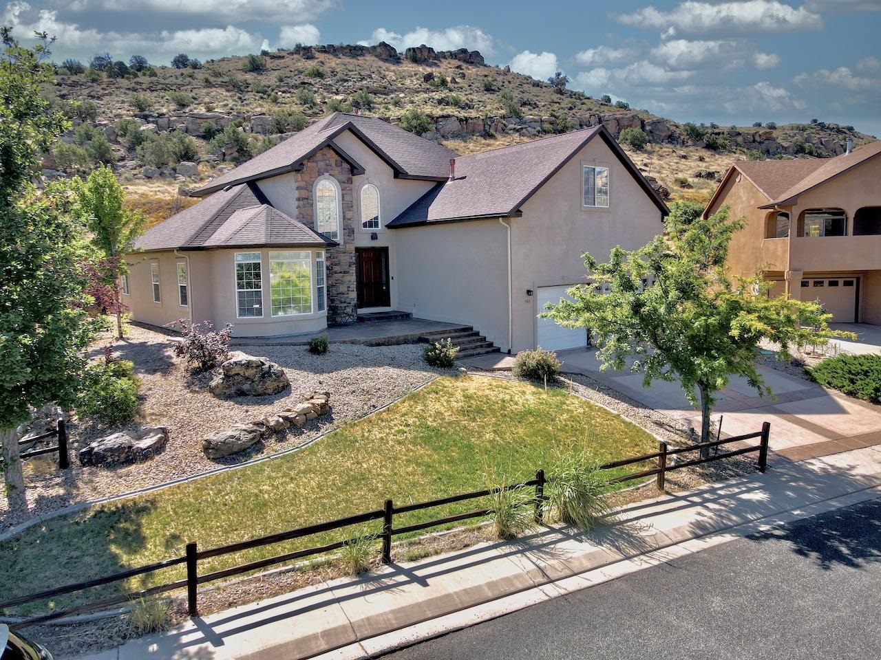 Spectacular views facing West towards the Colorado National Monument. This good looking  3 bed 2.5 bath, vaulted ceilings with a  beautiful stone fireplace. New kitchen cabinets with lovely  granite. New wood flooring in formal, nook and kitchen area. New carpet in bedrooms, stairs and Livingroom. New paint and  metal railing on the staircase. New vanities with granite in the Master, upstairs bathroom and the hall way bath. Nice new tile upstairs bath. New lighting and fans included in the formal dining, bonus room, Master bedroom, formal living room. The Master bedroom is located downstairs. One outside refrigeration has been replace. Outside of home new concreate on the South side and one side of the garage. The concrete has been resealed including New gutters. Ready to move in and enjoy the home. To the north of the home is a great hiking and biking trail. Several misc. items have been done. All information  including but not limited to square footage, measurements, pricing and availability are all subject to change/error without notice. Buyer's to verify all information.