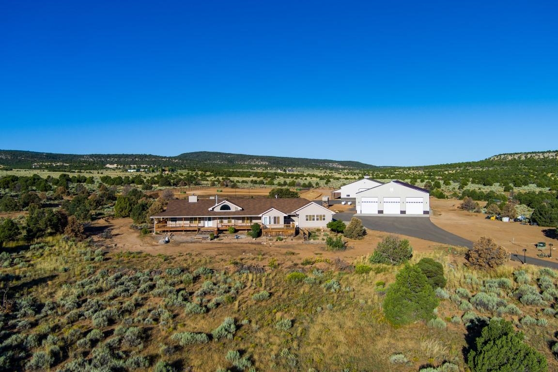 Enjoy Glade Park tranquility with a stunning equestrian ranch that has it all! This well-appointed 33 acres sits just at the top of Little Park Road. Through the gated entry follow the paved driveway to the ranch style home that boasts stunning views in all directions. The split floorplan has a wood burning stove in the spacious living room, a guest suite with private entrance, and vaulted ceilings. The kitchen has great counter space with plenty of cabinets. The warm master suite, with its own fireplace, opens to the back courtyard. The large front deck opens to a panoramic view of the Mesa and the Bookcliffs. Behind the home there is a giant 300’ by 200’ horse arena, with 6-rail pipe fencing, adjacent is the heated 120’ by 60’, 8 stall horse barn with concrete flooring. Not to be out done is the 80’ x 60’ shop that has 3 14’ wide doors and 16’ tall walls and a bathroom, all heated with in-floor heat. The land is enclosed to pasture your animals with a 5-rail pipe fence around entire property and a fence to have two separate pastures. Call today for your private tour!