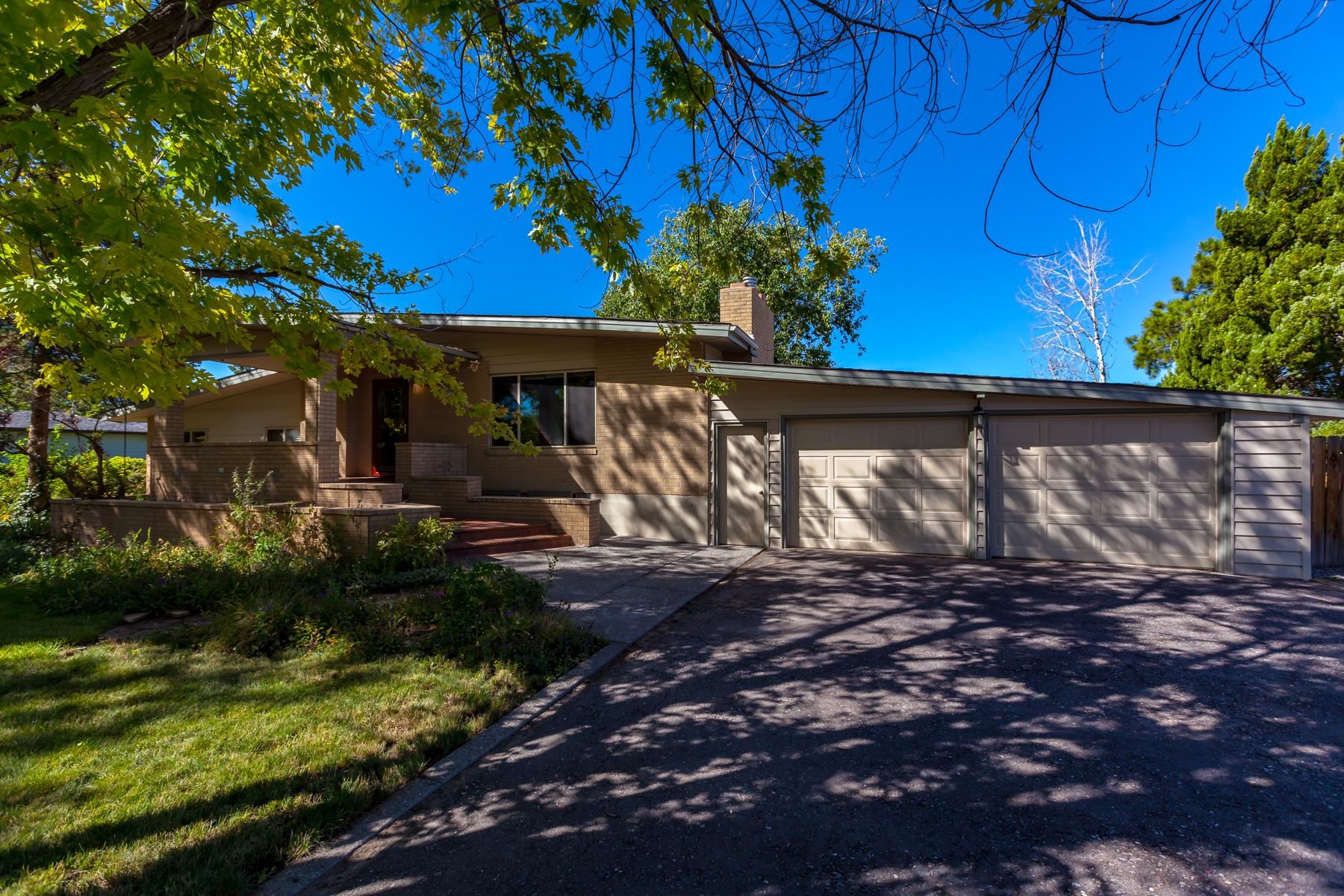 Welcome home to your own Western Colorado oasis! This charming Redlands home has everything you need and more. The moment you walk in the door you'll find a perfect mix of vintage details, modern convenience and beauty. The vaulted ceilings and large windows let in plenty of natural light and the gas fireplace in the main living area provides a beautiful focal point. The formal dining room has a charm all its own and the kitchen is a modern chef's delight! With plentiful storage, a dry bar, eating counter space, two wall ovens, and incredible views of the yard, rolling hills and the Colorado National Monument beyond, this may very well become your favorite room in your home! Just off the dining room and kitchen you'll find a large, 4-season sunroom - perfect for keeping an indoor garden and enjoying the views in all kinds of weather! On the lower level you'll find the primary suite with a 4-piece bath (shower and double vanity), a second 3/4 bath and a guest room. In the beautifully finished basement you'll find a second living space, ample storage, an additional bedroom, and a full bath. The outside space is as enchanting as the inside, with a large deck that has built-in benches, garden beds, mature landscaping including shady trees, a storage shed and of course, unbelievable views! The front yard is lush and inviting, with a large covered patio to enjoy as well. With a two-car garage and ample RV parking, you'll have room for all your toys, tools, vehicles, or gear to enjoy all the adventure the Grand Valley has to offer. Do not miss out on this incredible home in Grand Junction, CO!