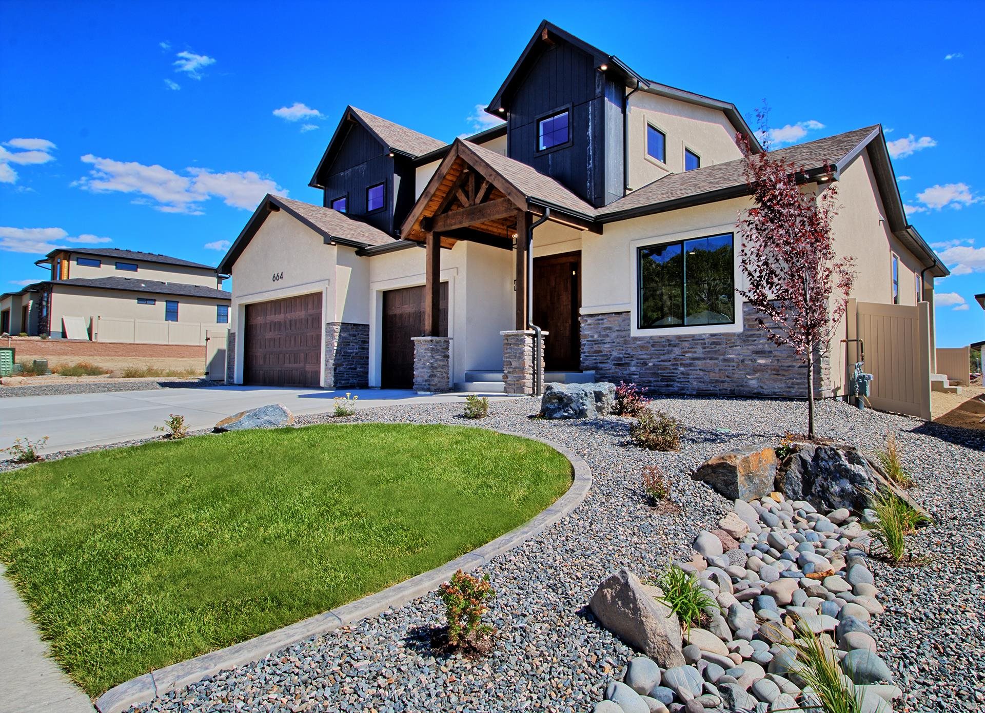 SO MUCH SPACE! This home will accommodate a large active family starting with the 5', custom made, eye catching, pivot doors that leads you through the 19' towering foyer. Living room has vaulted ceilings with 3 wood beams and a floor to ceiling stone gas fireplace. All this opens to a dream kitchen that is fully equipped with a 6 burner ZLINE gas/range oven with a range hood, farm sink, a 9' long island, ZLINE refrigerator, dishwasher, and built-in microwave drawer, plus built in wine rack, and a large pantry with built-in cabinets, quartz countertops, and extra shelving. The master bedroom is on the main level with tray ceiling, double-head shower, and walk-in closet, plus access to the laundry room. Extra washer/dryer area upstairs where there is 3 bedrooms (2 with walk-in closets), 1+3/4 bath, and a family room. 5th bedroom is on the main level with a full bath - could be an office/den. Beautiful views of Grand Mesa and Mt Garfield, and so close to all the city conveniences and hospital. Every detail describes perfection and location is prime.