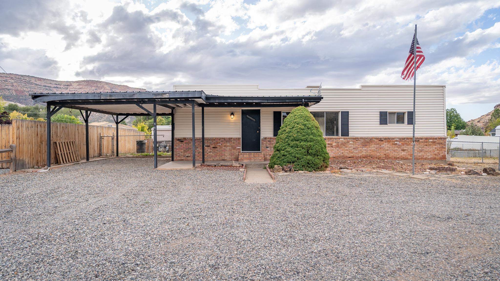 Nestled amidst the breathtaking vistas of the Colorado National Monument, this iconic 1960's modernist gem awaits its next fortunate owner. Set upon a sprawling .83-acre lot, this residence offers a rare opportunity to embrace the serene beauty of Western Colorado. The heart of the home, the kitchen, has been thoughtfully renovated, featuring new paint, updated electricals, and an all-new kitchen boasting modern amenities for culinary enthusiasts. Luxury vinyl plank flooring flows effortlessly throughout, enhancing both style and functionality. This home was refreshed in 2022, there is a wealth of potential for future customization. Whether you're unwinding in the spacious living areas or taking in the panoramic views from the comfort of your own oasis, every moment here is imbued with tranquility and possibility.