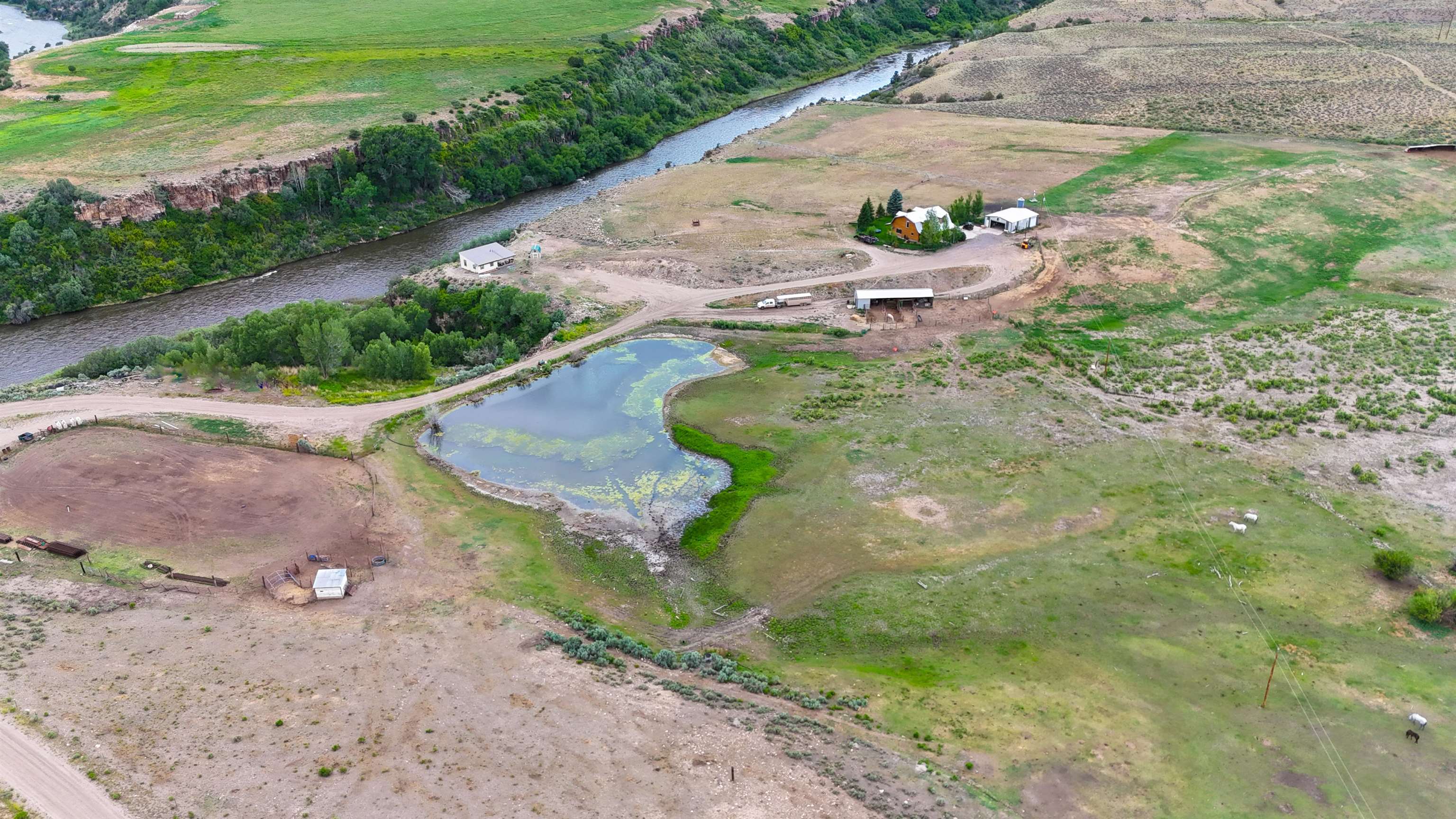 Colorado River Front Estate, located in Burns, Colorado, is the ideal mild climate horse property. This equine ranch sits at 6500 feet in elevation and sits an hour north of Exit 176, off of I-70. This 40 acres has a center pivot, an arena, horse runs with automatic water, and a tack room. It also has multiple pastures to be able to separate and graze horses or livestock. Colorado River Front Estate has two homes that sit directly on the Colorado River. The main home is a 1,855 sq/ft log home with 3 bedrooms and 2 bathrooms. The guest home is 900 sq/ft with 2 bedrooms and 1 bathroom. Both homes offer Colorado River views and mountain views. The tack room that is attached to the horse runs is 60x18, there are 3 horse runs that are 12x40. The shop/garage sits to the north of the home and measures 30x40. The mountain views from this property are absolutely impeccable but this property has more to offer than just mountain views. It also has the Colorado River running right through it and a road on the property that leads down towards the river as well. Colorado River Front Estate has BLM bordering 3 different sides of the property and sits in GMU 35. This unit offers over the counter elk tags. The pricing is listed with the transfer of the 70 head summer cattle permit near the property.