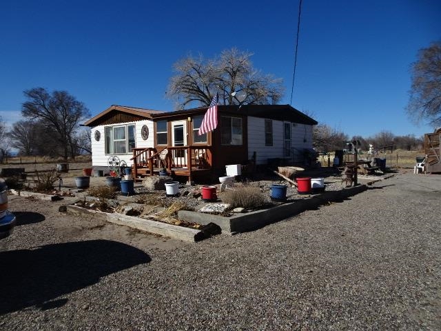 Currently zoned AFT - Mesa County; current use is residential. Master land use plan calls for the property to be annexed into City of Fruita and zoned commercial. Value is in the land with future commercial zoning. Property is surrounded by City of Fruita and in the commercial zoning path along Highway 6 & 50. The new Iron Wheel Subdivision is north across the Independent Ranchman's Ditch from subject. Home is comfortable and has been well taken care of despite its age. Master bedroom, living room, dining area, kitchen, full bath, and laundry are on main level. There is a small, enclosed entry porch. Basement is rough finished and has mechanical, storage, and two non-conforming bedroom areas. Detached office/ garage has large rough finished office area (approx. 28x40) with 1/2 bath and a 2 car garage (approx, 28x28). There is also an approximate 12x40 covered equipment storage attached.