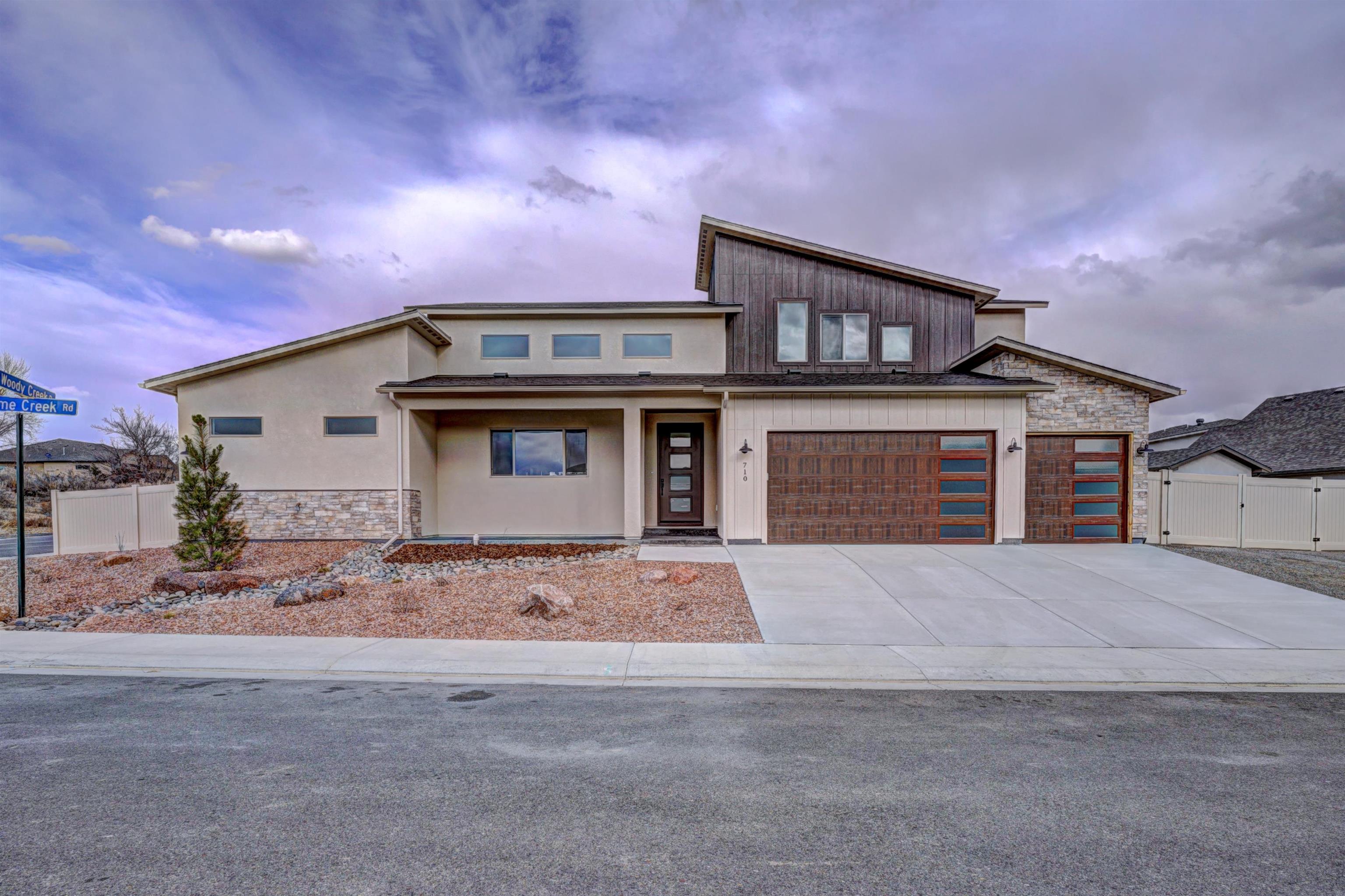 Get ready to fall in love with the gorgeous finishes and functional floorplan of this North Grand Junction home! This stunning 2,644 square foot property offers 4 bedrooms, 3 bathrooms and a 3-car garage. The spacious corner lot provides ample room for RV parking and the price includes front landscaping and fencing. The dreamy kitchen features a large island with seating, gas range oven, wet bar and walk-in pantry. It opens to the dining room and a sizable living room, complete with a cozy fireplace. In the primary suite, you'll find not one, but TWO walk in closets, along with a luxurious bathtub and a step-in shower. Two additional bedrooms, a bathroom, mudroom and laundry room can also be found on the main floor. The bonus room above the garage has its own bathroom and would make a wonderful 4th bedroom or a quiet space to use as you please. Construction features include a conditioned crawl space, 2 x 6 walls with blown-in insulation and an engineered foundation.