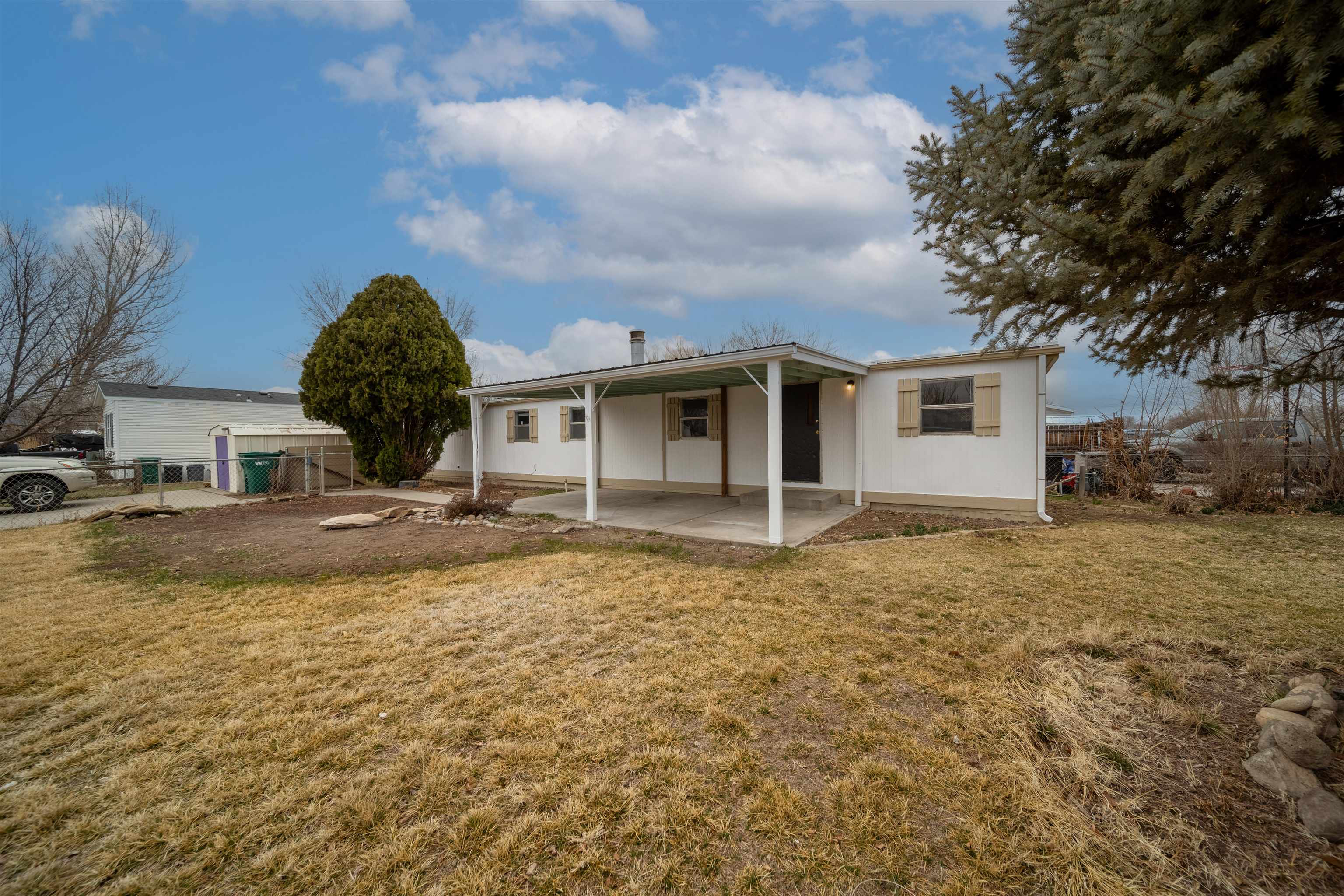 Affordable mobile home on its owned lot in Fruita! Located directly across from a park in Holly Park Subdivision.  Fresh exterior and interior paint.  HOA is for Irrigation Waters.  There is a separate secured lot for RV Parking.   Home is not currently purged, however Seller's have an estimate and are willing to purge if required for Buyer financing.  Come see it today!