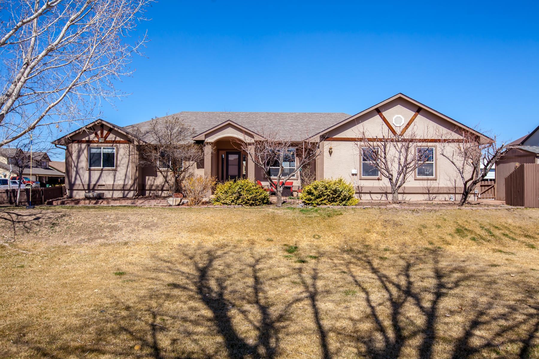 This custom Ranch style home, on over 1/2 acre lot, offers privacy along with epic Monument views. It sits within walking distance of charming downtown Fruita convenient to markets, concerts, festivals, and great food. The home features many updates and upgrades including a new roof, new max-cool cooler, new lighting, stylish new fireplace mantle, hardwood flooring, and a large covered patio for outdoor enjoyment. A big fenced yard includes fruit trees, raised garden beds, RV parking, and space for toys. The attached garage is over 800 sqft and includes a 12x23 workshop area. There is a bonus room in the outdoor heated/cooled office or craft area. This space is awesome! This home is close to so many recreational opportunities! Tennis courts, hiking, rafting, and skiing. Enjoy this home and the great outdoors. Don't miss the chance to make it yours.