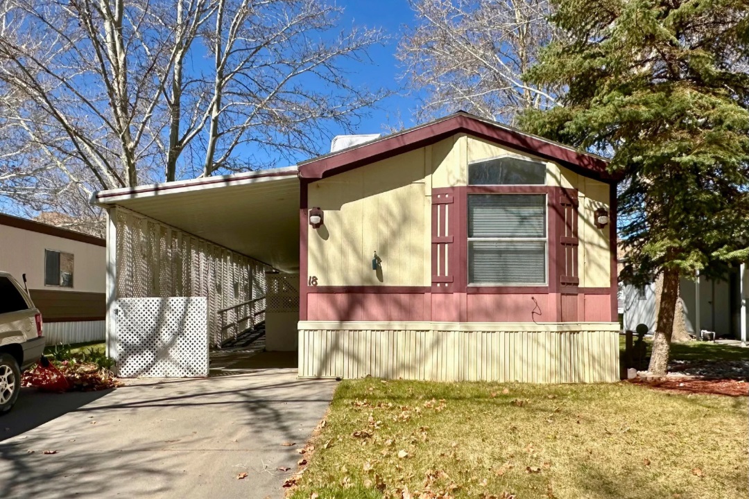 Spacious home in 55+ plus community in Palisade.  Enjoy summer evenings in a quiet and peaceful Palisade park.  Covered ramp to access home or remove and make a large covered patio space.  Home has an evaporative cooler and two window refrigerated air units.  Complete with a shed in the back yard.  Hot water heater & roof are less than 10 years old and a furnace was installed in 2023.  Home is being sold "AS IS".