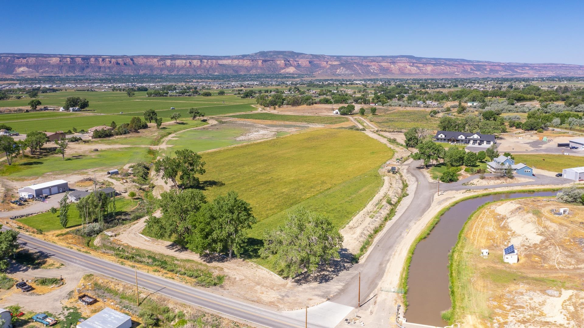 Opportunity awaits! This 6.23 acres is located in one of the most desirable locations in Grand Junction and boasts opportunity and options for growth on beautiful level ground currently in pasture! This parcel includes 5 shares of GVIC irrigated acres and is perfectly located just minutes from the city park, restaurants, healthcare facilities and more while still providing you with the peace and quiet comforts of country living. Bring your vision and make your dream a reality!