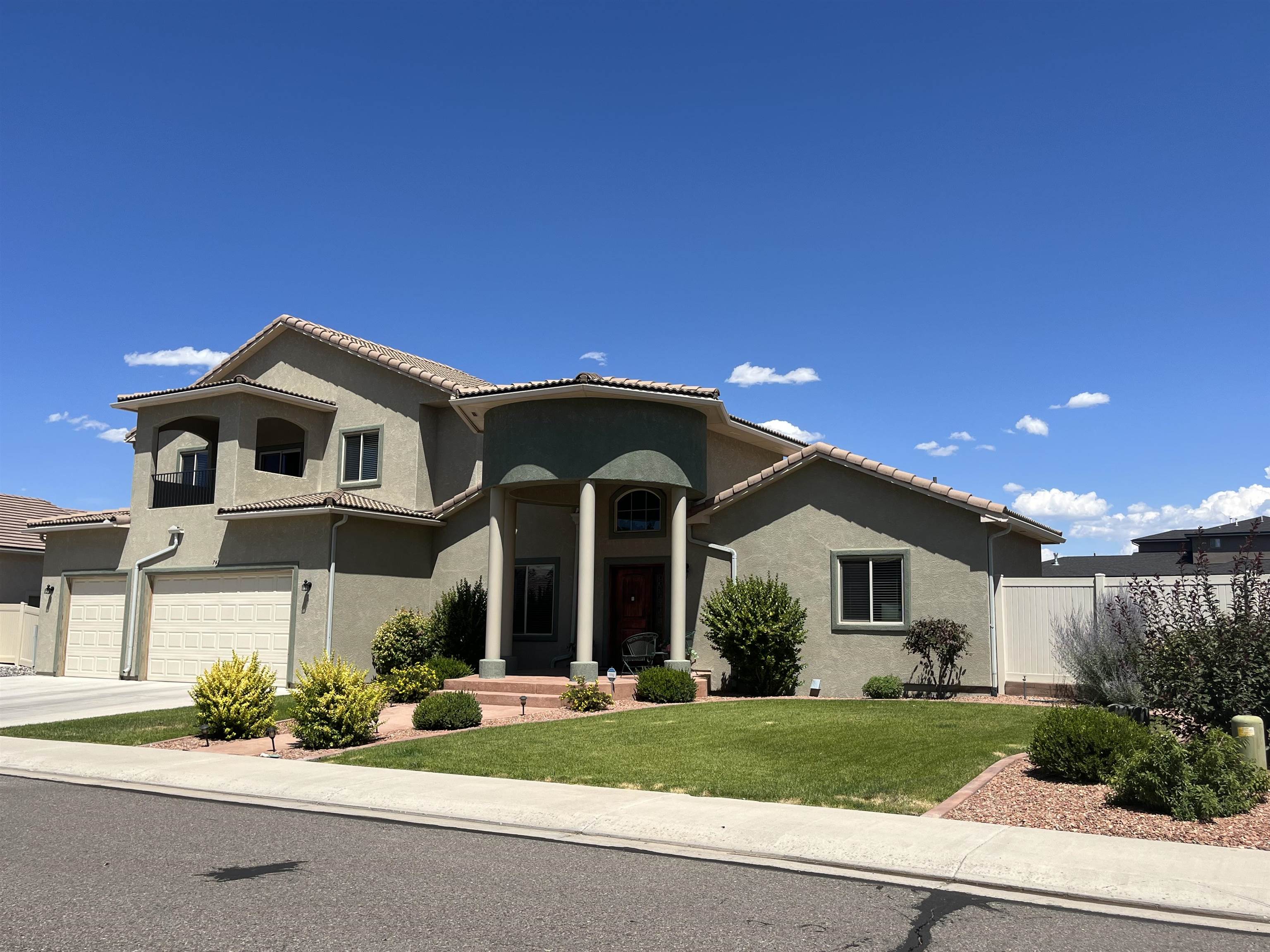 Beautiful 2 story stucco home on 1/3 acre landscaped lot with fully fenced very private backyard which includes a large garden area with 3 raised garden beds and covered patio on the shady East side.  Open floorplan with granite kitchen, wood and tile flooring, stainless appliances (GAS range/oven), gas fireplace, and a formal dining space. The primary suite with 5 piece bath plus an additional bedroom (currently used as an office) and full bath is on the MAIN level. The second level has 2 additional bedrooms, full bathroom and additional living room with an upstairs deck.  Lots of storage and spaces for everyone's activities.  There is a tile roof and attached 3 car garage with refrigerated central air and Gas forced air heating. Close to all the Grand Junction amenities!  Easy to see...take a look!