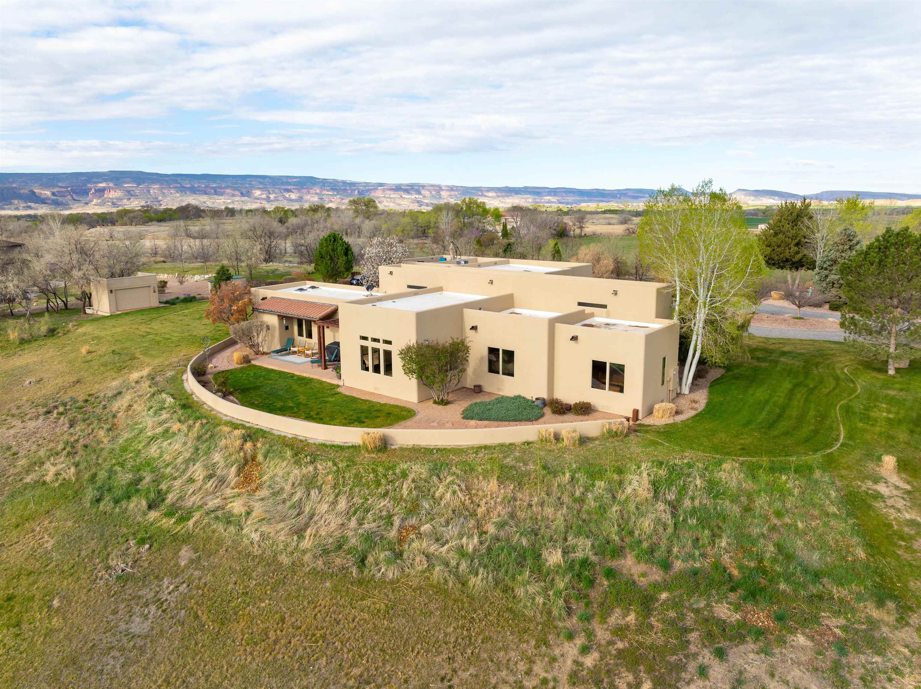 A custom-built Spanish stunner perfectly perched to take in 360-degree Grand Valley views from every window and courtyard.  Quality 2x6 construction and beautiful finishes compliment the interior throughout.  The primary suite has been updated and an additional 882sf bonus room and office area was added in 2018, outside you'll find a freshly painted stucco exterior and a roof top deck that will take your breath away. Words don't do this one justice, book your private showing today!