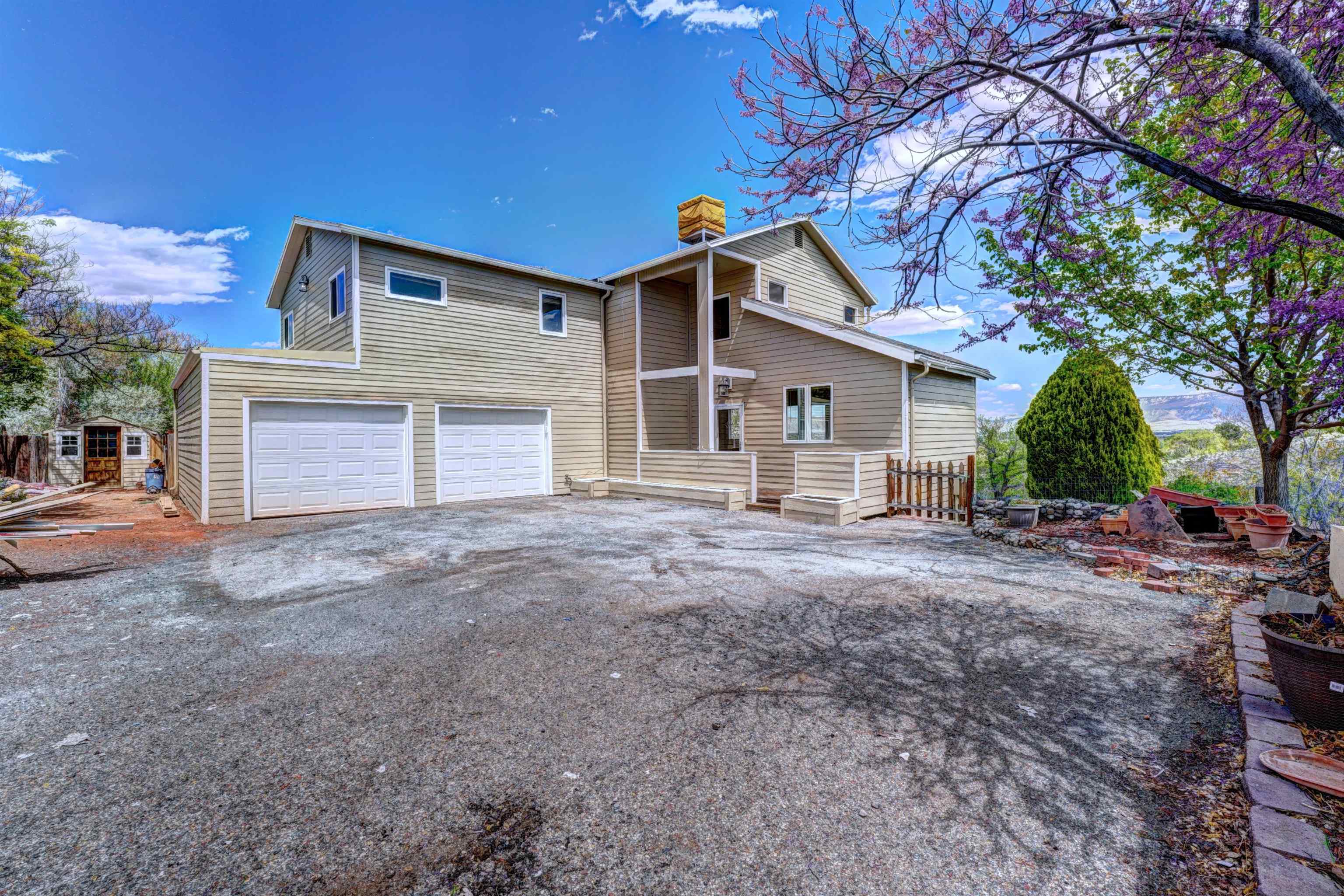 **Open House Friday April 26th from 3-6 PM **Step into your next home with this great 5-bedroom, 2.5-bath home, spanning over 3,300 square feet in the Ridges neighborhood. Freshly painted inside and out, this residence has beautiful unobstructed views of the Book Cliffs, Mount Garfield, Grand Mesa, and twinkling city lights at night. The living area has high ceilings with abundant natural light creating the perfect place to entertain. The fully finished basement offers the perfect arrangement for multigenerational living, with a kitchenette and private deck.   Equipped with a newer roof and backed by a comprehensive pre-inspection, this home is VERIFIED and includes a 12-month home warranty at closing.