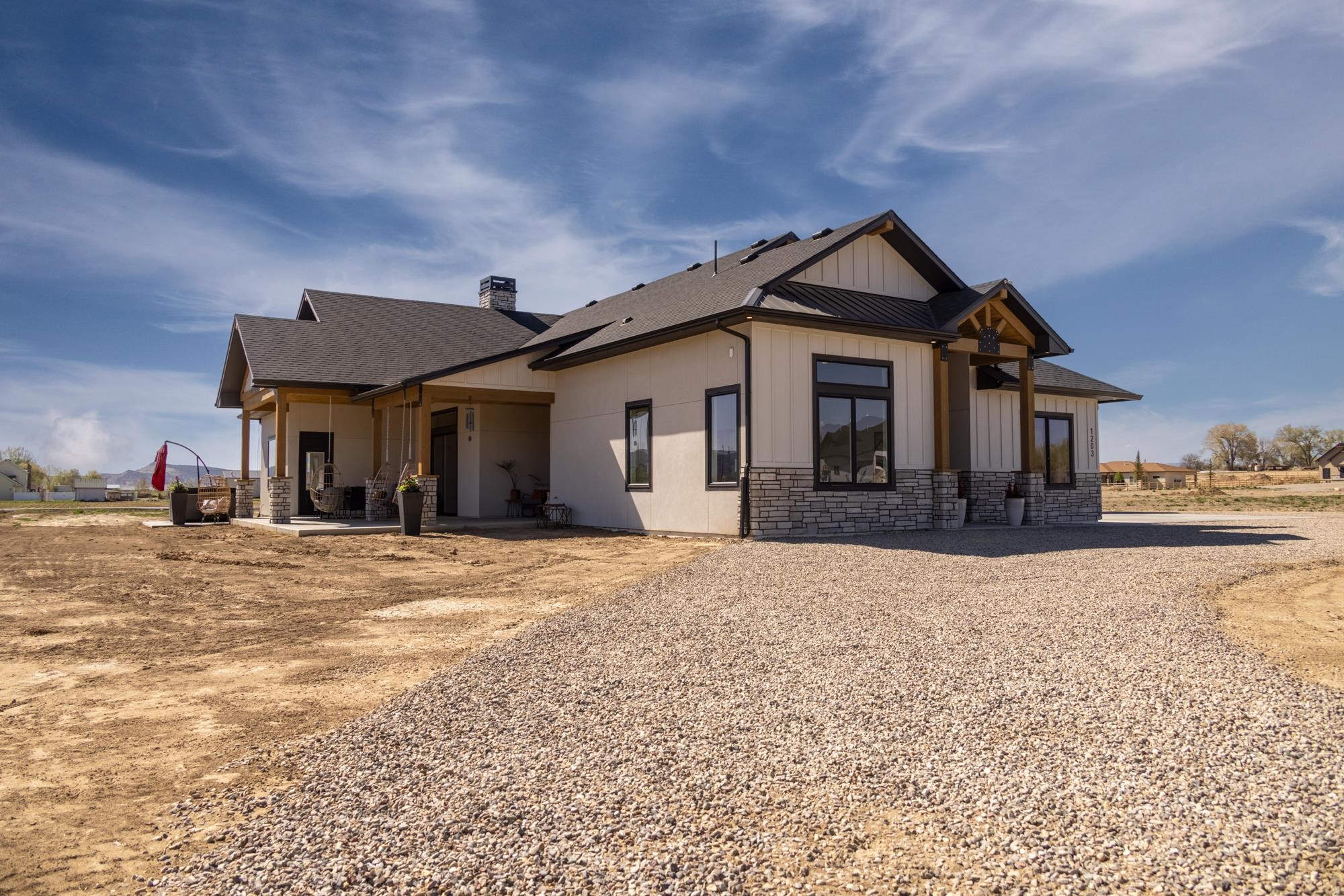 Thoughtfully designed and built by Alta Home Builders on an acre with views just minutes from Fruita’s community center, brewery, coffee shop, hospital, gym and grocery store, this home has it all! Great for multi-generational living, the split floor plan boasts a luxurious primary suite and a beautiful junior en suite, each complete with walk-in closets and stepless showers. Comfortable outdoor living space flows seamlessly into the open concept living room, tied together with sustainable tongue and groove beetle kill pine, a finish which is echoed throughout. The double covered patio offers gas and electricity for an outdoor firepit or kitchen, and the primary bedroom is ready for a hot tub under the stars and facing unobstructed views of the Colorado National Monument. A gorgeous gas fireplace with hand-crafted, rustic shelving and hidden audiovisual storage command attention at the heart of the home.  Classy quartzite countertops add elegance to a practical kitchen with views of the Bookcliffs. A well-appointed butler’s pantry, complete with a prep sink, beverage cooler, cabinetry and wine storage keeps small appliances tucked away in a tidy workspace.  Designed to flex along with the needs of a family all on one level, the primary suite offers a spa feel with a gorgeous, tiled shower designed for aging in place in style or spoiling yourself every day. The middle bathroom includes an oversized soaking tub finished in a glamourous polished tile, serving two additional, spacious bedrooms or hobby rooms.  Finally, the heated, attached 1,500 sf garage with a tall RV garage bay provides storage for trailers, campers and toys, or a wonderful workshop, helping homeowners avoid the additional cost of building a shop on the property. Come see if this is your dream home!