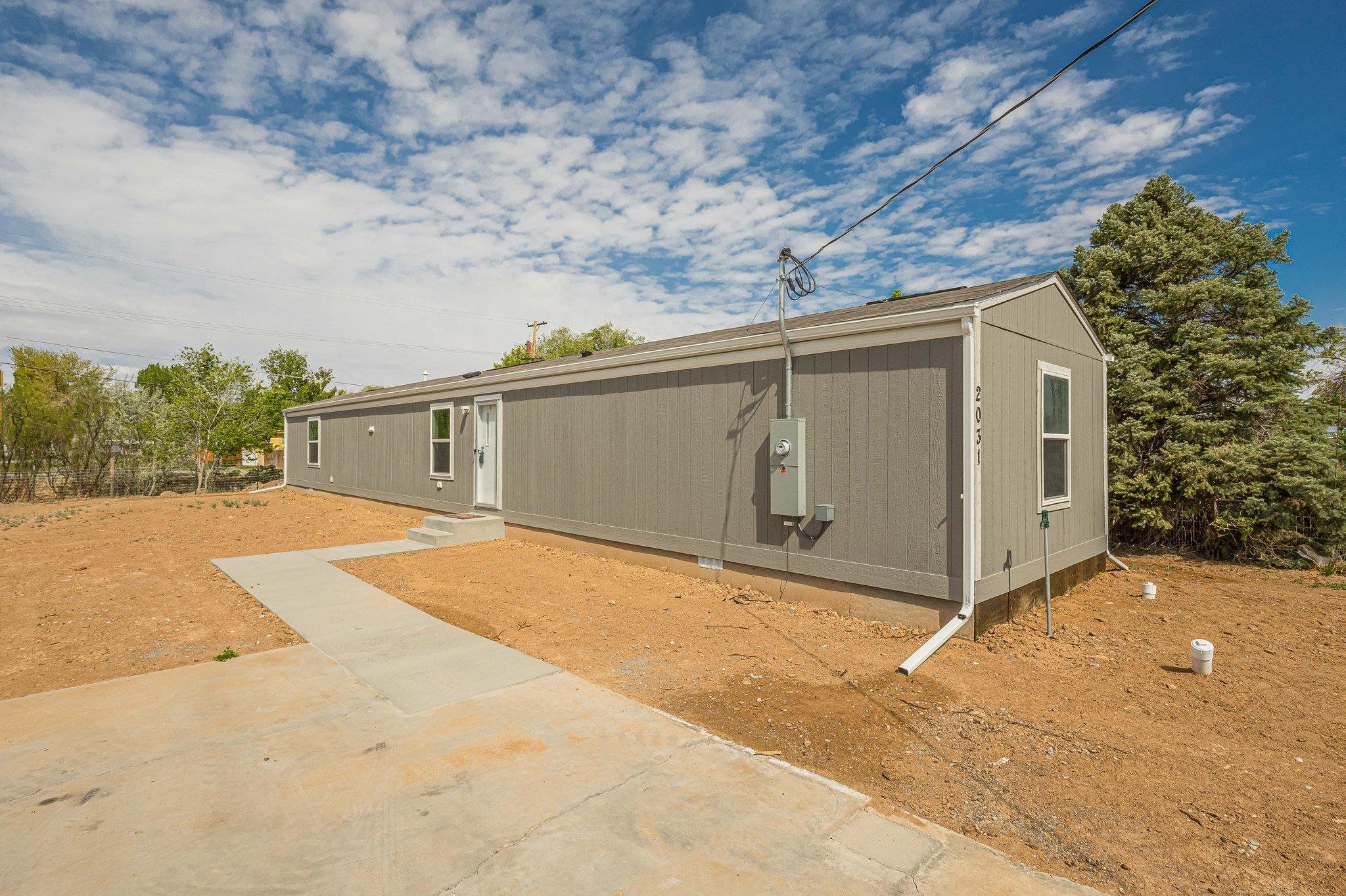 Country feel, city close in this brand new manufactured home on Orchard Mesa.  This 3-bedroom, 2 bath home features a split bedroom design. 2 full bathrooms and an open kitchen with plenty of cabinet and counter space.  The primary suite includes a full bath and a walk-in closet. The secondary bedrooms share another full bath. This is a zero energy home with upgraded insulation and a fresh air circulation system.  The hot water heater even has blue tooth capability. Outside, you will enjoy the rural feel of the property and there is plenty of RV parking a storage shed for additional storage and NO HOA. For your convenience, the seller has thoughtfully installed RV dump, hookup and 50 amp plug.  The landscaping is a blank slate and ready for your design.  Irrigation water is paid through taxes.  Call for your private showing today.