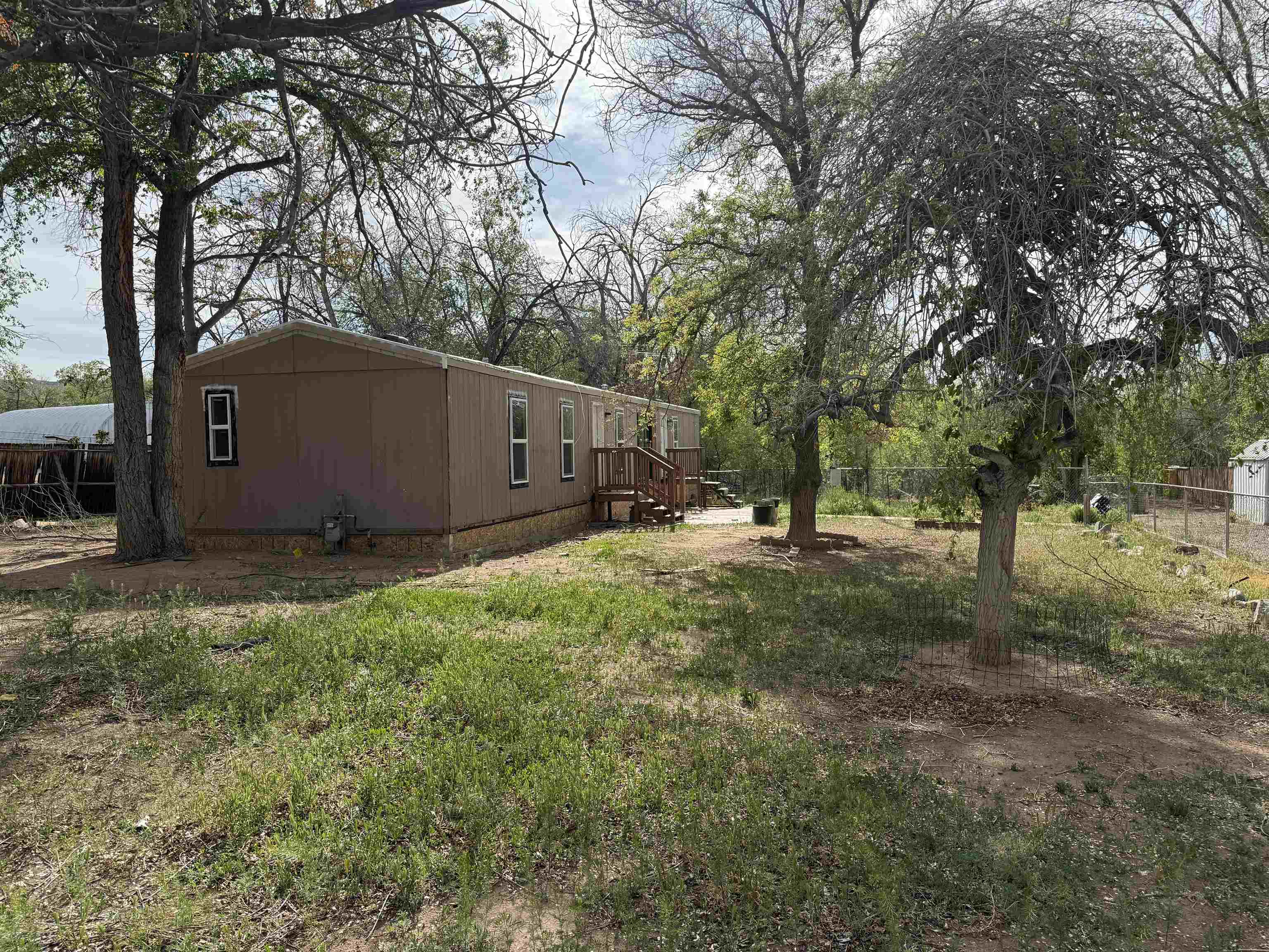 Hidden Potential.  Redland fixer situated on a large lot in a county feeling.  Minutes to downtown Grand Junction. The home has been totally gutted except for the custom showers and new windows. Get the opportunity to finish the home the way you want. Home has an engineer Certification, and it does not appear that the unit has been moved except from dealer to site.  Sold As is. Cash only. See it today!!