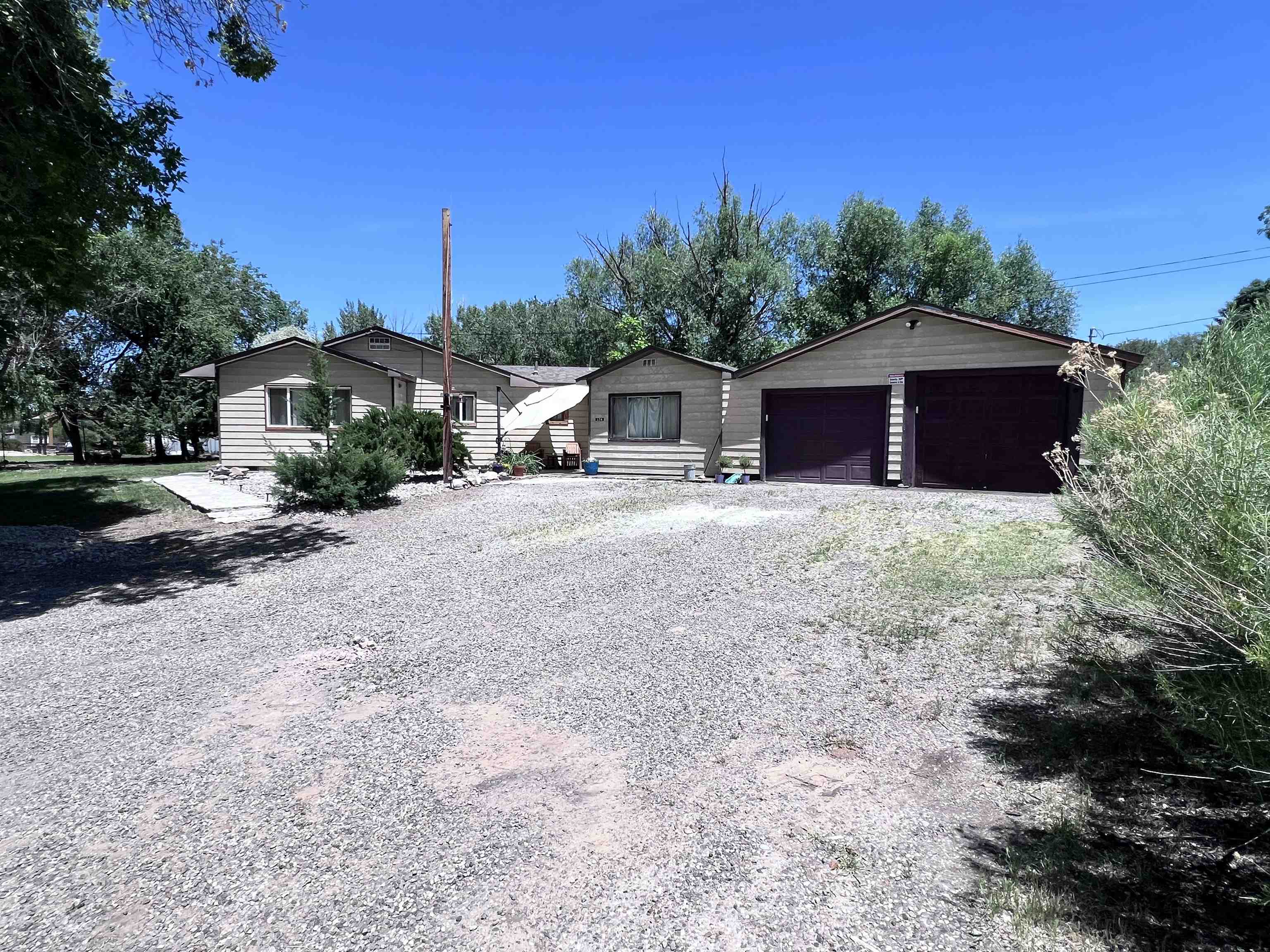 This tranquil home was recently remodeled and, at over ½-acre, there is plenty of fully-shaded space for all of your toys at this secluded paradise! The comfy remodeled home features a new 40-year roof, upgraded electrical, new plumbing, new windows, new insulation, all stainless steel kitchen appliances and stainless steel countertops, and a heated/cooled/insulated garage.  Come home to your spacious wooded sanctuary. Located down a long gravel driveway at the back of a cul-de-sac, there is no traffic. daily visitors include deer, fox, squirrels, owls, hawks, hummingbirds all enjoying the naturally wooded oasis that is surprisingly just a few minutes to downtown.