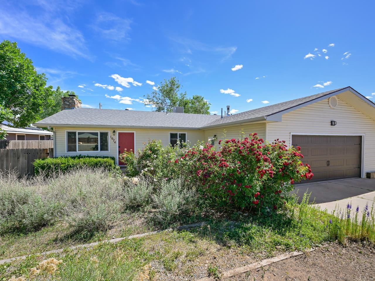 Come see this comfortable and charming property in the heart of Fruita, Colorado! Just a few blocks from downtown, this home is in a prime location with no shortage of nearby amenities. You'll find yourself close to schools, shops, restaurants, and parks, ensuring you're never far from what you need. As you approach the home, you'll be greeted by beautifully maintained garden beds out front, filled with flowers and shrubs ready to bloom. Step inside and be welcomed by a large living space featuring hardwood flooring, a stone electric fireplace, built-in shelving, and an accent wall that perfectly completes the room's cozy atmosphere. The updated kitchen showcases beautifully painted cabinets, a modern backsplash, that compliment the stainless steel appliances and laminate countertops perfectly. Enjoy a meal at the counter or in the combination dining space, which provides access to the inviting back patio. Down the hallway, you'll find additional bedrooms offering versatile spaces that can be used as a home office, craft studio, or hobby room. The primary suite offers plenty of space, abundant natural lighting, and a double-door closet. The en-suite bathroom is charmingly updated, featuring a tiled backsplash on the shower/tub and a roll-down shower curtain for ease of use. The oversized two-car attached garage provides space for workbenches or shelving, perfect for projects or additional storage. Step out to the back patio to enjoy al-fresco dining or lounge in the sun. The landscaped backyard offers mature trees, a shed, and several garden planters, ideal for practicing your green thumb. Recent upgrades to the home include new roofing, windows, a water heater, and an electric panel. Don't let this opportunity pass by! Schedule your showing today and experience all that this delightful Fruita property has to offer.