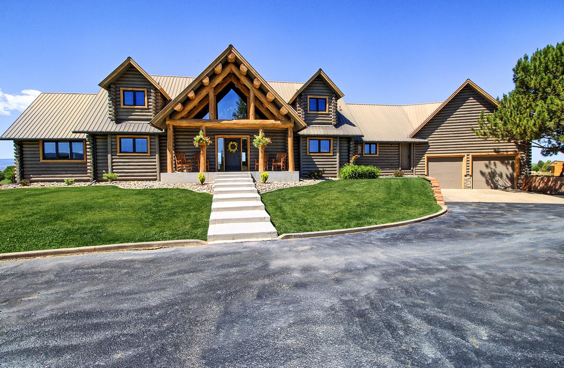 The incredible feel of a contemporary mountain log home awaits you on a picturesque 6-acre setting in the premier North area of Grand Junction,  among some of the most sought-after real estate in Western Colorado.  Framed structure, chinked log siding, metal roof, dormer windows, vaulted ceilings, and elevated panoramic views all add to the ambiance of this home.  5 Bd, 5 Bth, +office, multiple living areas, floor-to-ceiling stone fireplace, and huge deck for entertaining.  Hardwood floors, stainless steel appliances, and granite countertops are just a few upgrades you will see.  The master suite has an enormous walk-in closet, center island dressers, and a hot tub out it's back door.  If you have bikes or horses and want a place to ride them this is a dream come true, the trails of the western Colorado desert are right up the road.  Plenty of room for a shop, garden, greenhouse or whatever your heart desires.  This incredible property offers true end-of-the-road privacy.