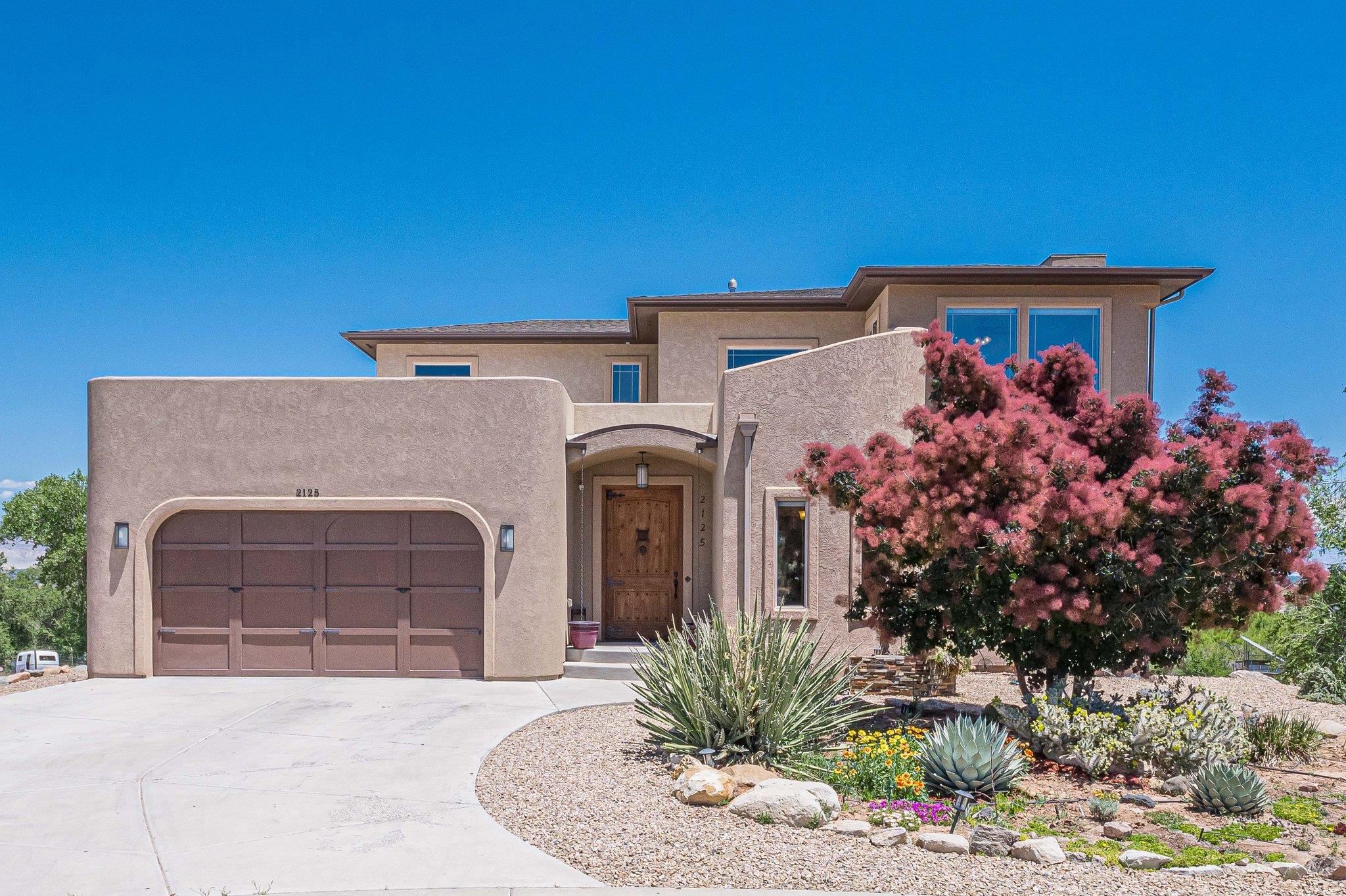 Spectacular views of the Colorado river, the Colorado National Monument, Bookcliffs and Grand Mesa, surround this 5 bedroom, 4 bath, home with numerous recent updates and a basement apartment that has it's own separate entry. Enjoy sunrises and sunsets gleaming off the river from your 40 ft. by 9 ft covered deck.  Updates include fresh paint, new flooring, new cook top stove and oven, some new windows, stainless steel refrigerator, new finishes in the basement, and the list goes on.  Other features include granite counter tops, Jack and Jill closets, gas log fireplace, walk-in-shower, fenced back yard, sprinklers, a humidified room that is ideal for musical instruments, a bonus room perfect for an office, and more. The premium location of this home allows you to be close to hiking and biking trails, shopping, schools, Colorado river, as well as the Colorado National Monument, fishing, summer festivals, wineries, and views of the Walker wildlike area. .