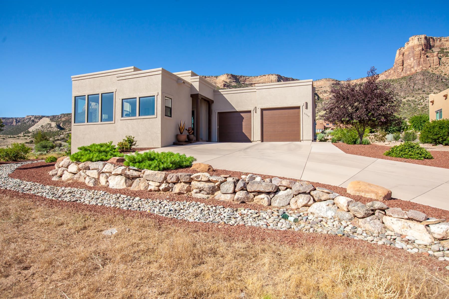 This custom home built by Griffin Concepts in 2019 is beautifully finished with custom cabinetry throughout, quartzite countertops with tile backsplash in kitchen, and quartzite counters in bathrooms, solid wood doors, 6" white oak flooring, and amazing large windows to allow abundant natural lighting in and provide views in all directions. Three bedrooms plus a spacious office, three bathrooms, two car garage with adjoining exercise room or shop. The walk in pantry is huge, has a wine cooler, and provides abundant storage to keep the kitchen uncluttered. Phenomenal, spacious master suite with custom closet and walk in shower. The home has been freshly painted and landscaping updated with a complete drip system.  Enjoy the amazing views of the monument from your covered patio.  This is truly a unique property that has it all.