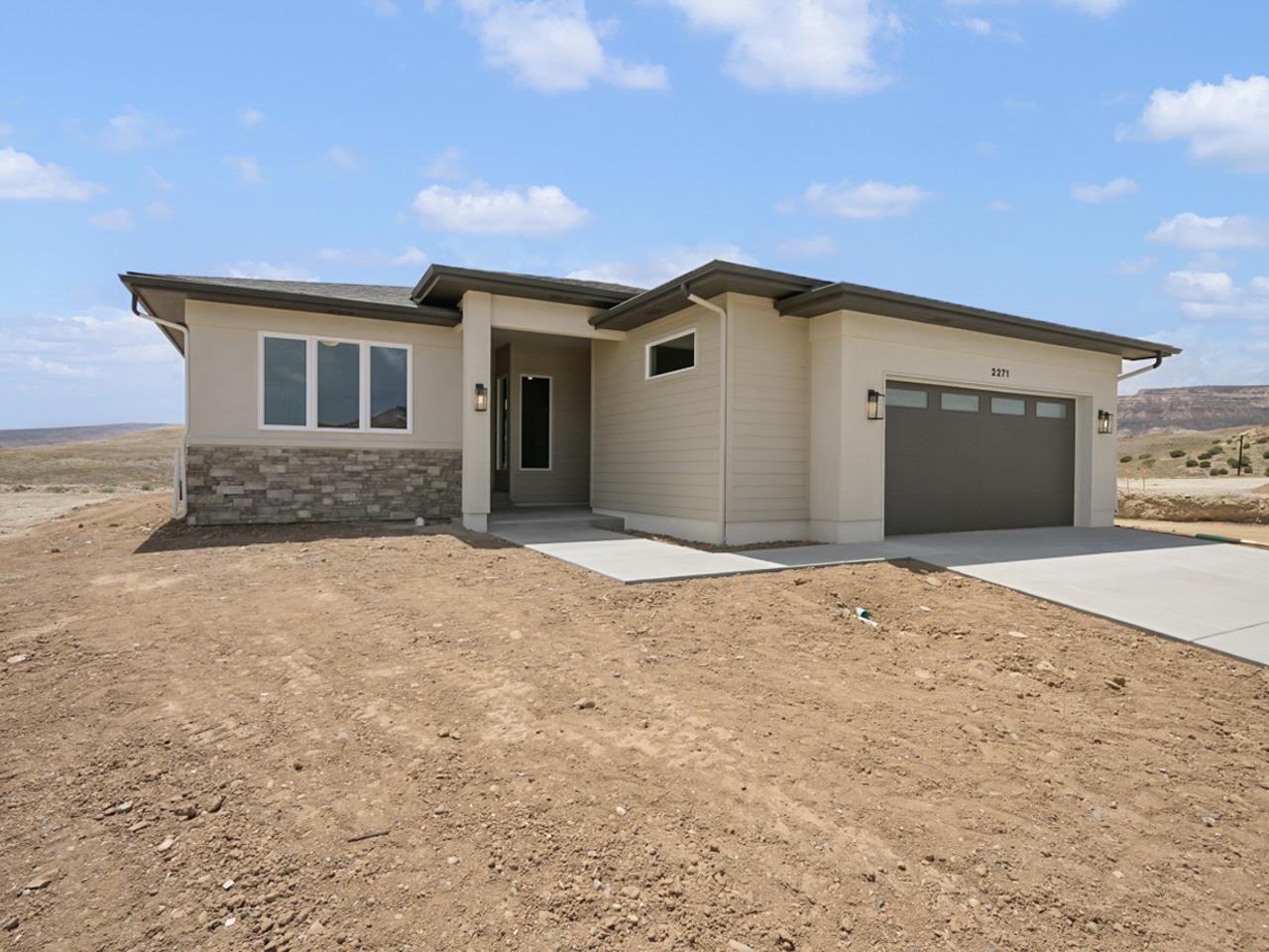 We are excited to announce that the award-winning builder, with over 35 years experience, Goetzmann Custom Homes, is building in Grand Junction. Come visit our model home in the Easter Hill community of Redlands 360. This particular home is move-in ready, and is perched on a bench, offering views of the beautiful surrounding areas. Your home tour will begin with a front entryway with a private courtyard, tucked away and the perfect spot to enjoy your morning coffee. The open concept great room, prep kitchen, and dining areas feature soaring 12' ceilings. The large covered back patio offers the perfect setting for entertaining as you watch the sun go down. Or, on those cool Colorado evenings, enjoy the cozy gas fireplace in the comfortable great room. The gourmet kitchen comes with quartz countertops (also throughout the home), stainless appliances, fabulous pantry, and will delight the chef of the family. Enjoy your meals in the comfortable dining room or take it outside onto the covered patio. The spa-like primary bath has separate vanities, a spacious shower and a free-standing tub. The main level also features two additional bedrooms and a bonus room we refer to as the Zoom room. This additional space offers the flexibility of creating a small office, workout room, or hobby room. Oh, and one additional wonderful feature is the over-sized 2-car garage. Perfect for storing your outdoor gear, tools, gardening supplies, etc. The neighborhood, Redlands 360,  encompasses more than 600 acres and will feature open space and a variety of trial systems. Literally, the trail system is just footsteps out the backdoor. Ready for your next mountain bike adventure, hiking excursion or simply taking your dog out for a quick walk? You can not beat this location for enjoying the vast terrain and stunning views.  Beautiful open concept, offers phenomenal views of Easter Hill and the stunning National Monument. Contact listing agent for details on other available lots and homes in this neighborhood, and visit our model home just down the street from this location.