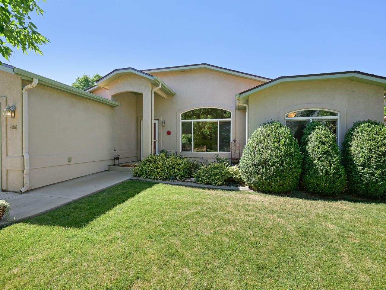 Situated in the peaceful and quiet Monument Village subdivision is your new dream home! Ideally located in the Redlands, you’ll find there are many amenities nearby, and you’re just a short drive from town. Even better, is the fact that you’ll be near plenty of outdoor activities. The Colorado National Monument and its many trails are just beyond your door. Speaking of the Monument, there will be plenty of it to look at from your property given the views of the area. One of the first things you’ll notice about the home is the well manicured exterior. Mature trees/bushes and a lush green lawn greet you as you pull up to the driveway. Step indoors and notice the open feel the main area of the home has. Vaulted ceilings provide a roomy comfortable atmosphere, which is perfectly accented by the gas fireplace with ample shelving that surrounds it. The kitchen has an open design with stone countertops, some stainless steel appliances, a sit-up counter and loads of pantry space. The dining area just off the living space, and kitchen provides easy access to the backyard and the artistic fixture that hangs down compliments the area well. The primary suite provides ample space and some great natural lighting. The 4 piece en-suite bathroom has a dual sink vanity, walk-in shower (complete with a seat), and easy access to a large walk-in closet. The additional bedrooms on the other side of the home are generously portioned and have easy access to the full bathroom. Step out back to a yard that you’ll absolutely love! Enjoy the mature landscaping with Australian pines and perennial gardens which attract pollinators, making for easy care. PLUS the HOA takes care of the mowing (provided the yard remains open). Sit back on the shaded patio and enjoy the views of the Monument. You’ll find the outdoor life will be unmatched in this “you gotta see it to believe it yard”. The home also includes tons of upgrades throughout. These include many of the appliances, the evaporative cooler, water heater, flooring, bathrooms, and even more. Don’t sleep on this opportunity to own a stunning, clean and well groomed property in the heart of the Redlands. Schedule a showing today!