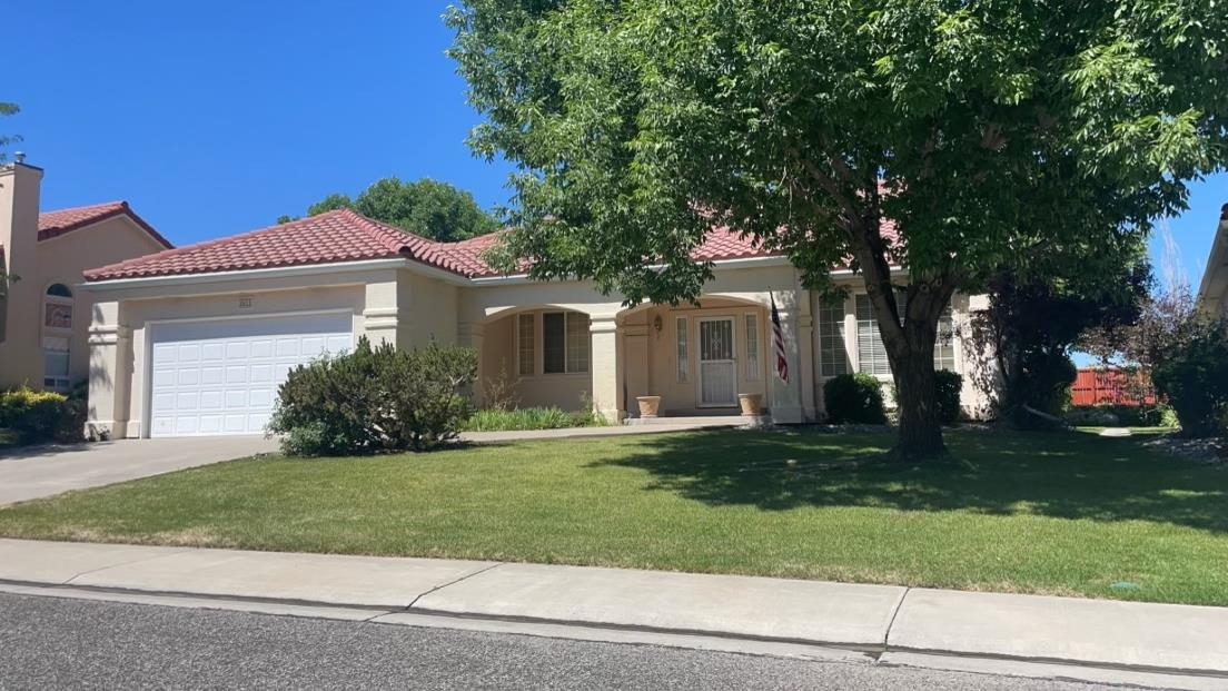 Experience the perfect blend of convenience and elegance with this beautiful lock-and-leave home located in the heart of Grand Junction. Attractive stucco facade and tile roofing evoke a classic Spanish aesthetic. The HOA takes care of front and backyard landscaping, ensuring guaranteed curb appeal and stress-free maintenance. Enjoy a spacious living area with a cathedral ceiling and a cozy gas fireplace, an attractive dining space perfect for gatherings, and large kitchen with a breakfast bar island, abundant cabinetry, and durable tile countertops. Luxurious primary suite offers en-suite bathroom with dual vanities, a soaker tub, a walk-in shower, and a spacious walk-in closet. A beautiful covered patio overlooking manicured grounds, accessible from both the main living area and the master bedroom. Two more generously sized bedrooms with ample closet storage offer plenty of living space. Corona del Ray offers tranquility, peace, and quiet. At least one resident must be 55+ and able to verify age as this community is age restricted. Experience lock-and-leave convenience; Ideal for those seeking a hassle-free lifestyle with the convenience of city living.