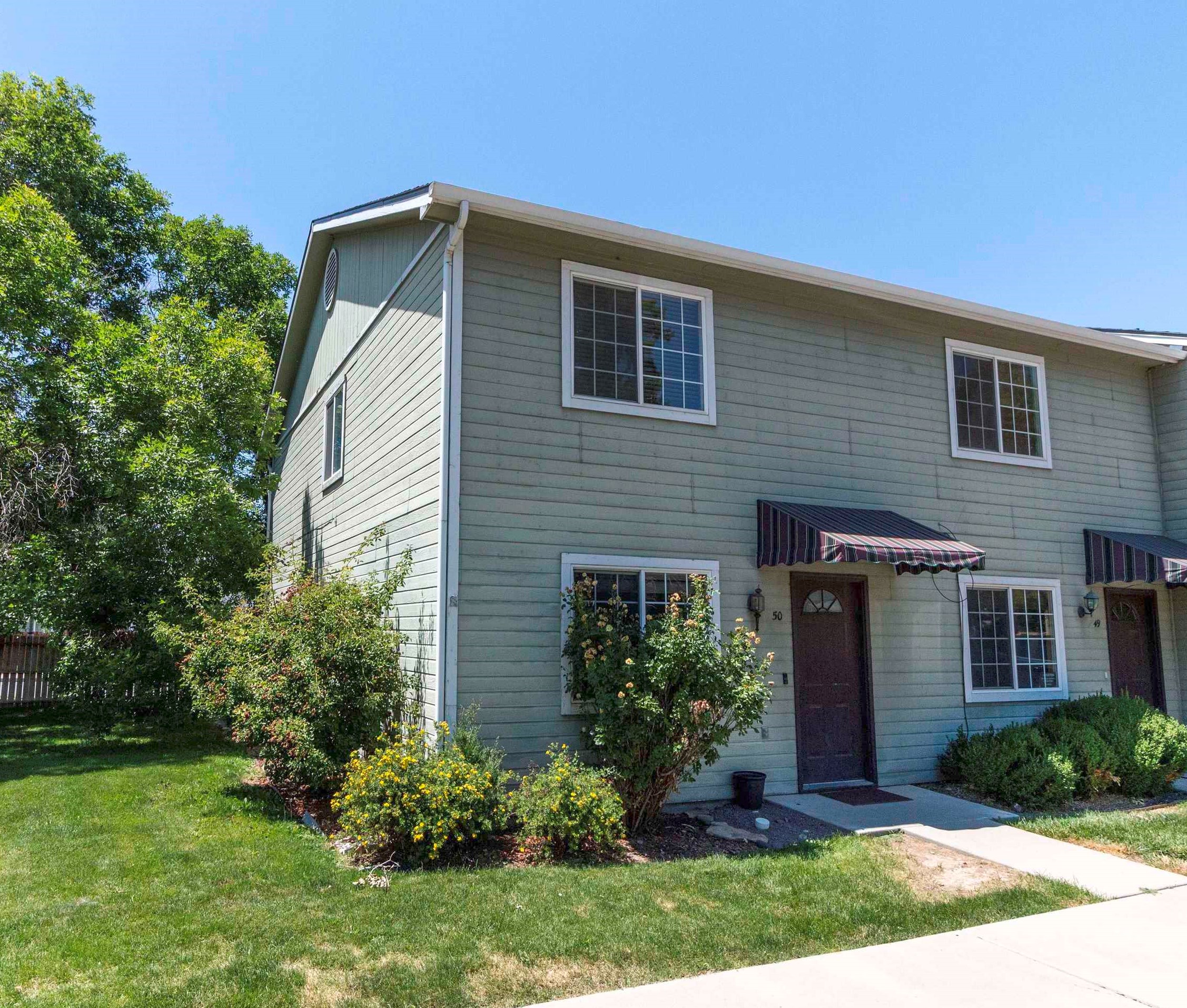 Cute, Cute, Cute! Not only is this townhouse darling, but it has a new roof, the HVAC has been completely serviced, there's a large, under the stairs storage area and a petite outside seating area has been added, too! Corner unit surrounded by a large fenced, grassy area. HOA takes care of Water, Sewer and Trash. Updated kitchen and freshly cleaned carpets make this cozy space a wonderful place to be!