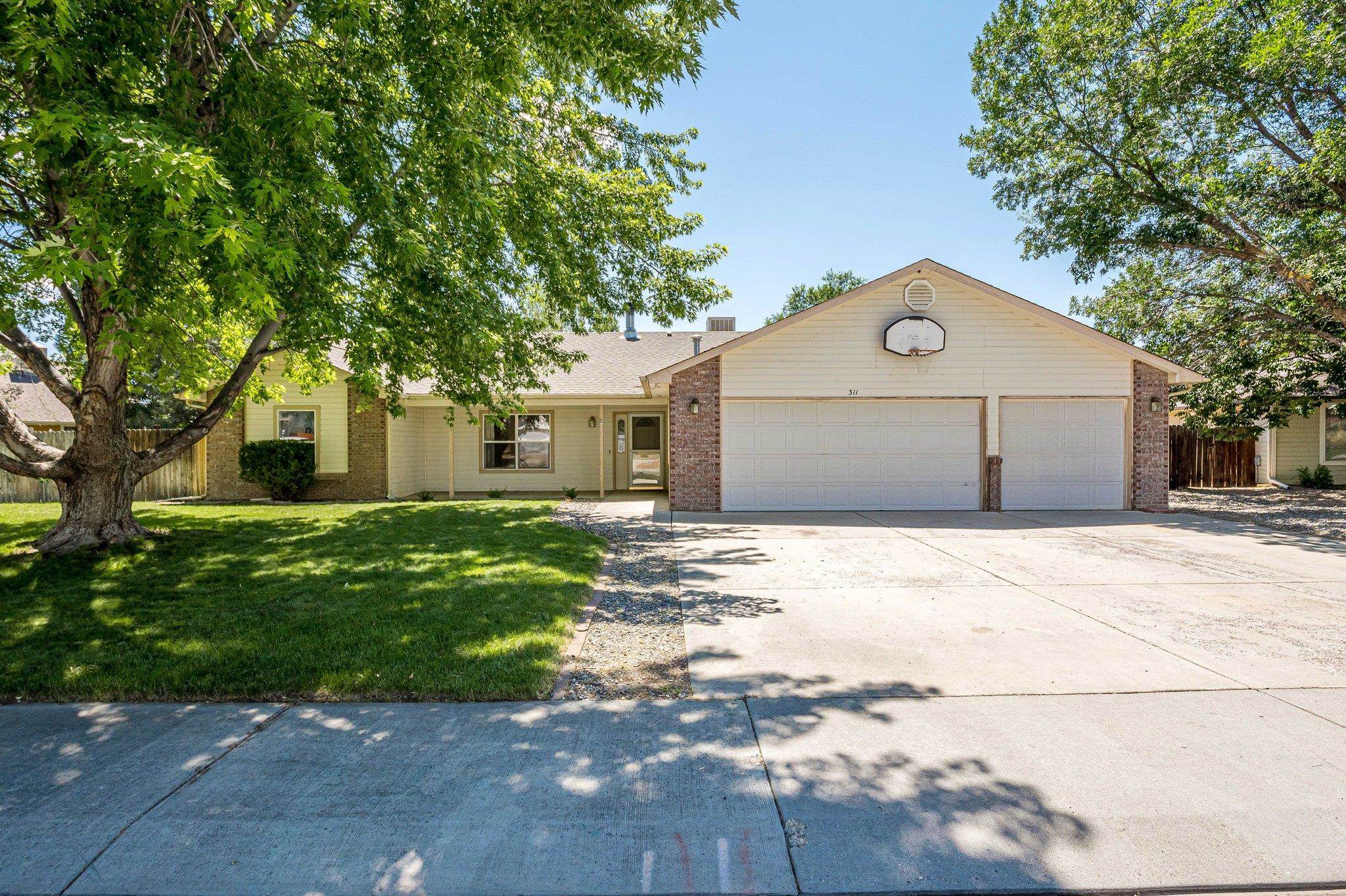 Are you looking for a home on a large lot within walking distance to downtown Fruita and recreation?  Welcome to this 3 bedroom/2 bath home situated on a spacious .34-acre lot in Fruita.  The thoughtful layout provides privacy with a split bedroom design.  The open living area features vaulted ceilings and an EPA certified wood burning fireplace.  It flows seamlessly into the large kitchen, complete with all appliances and breakfast bar overlooking the dining area.  The private owner's suite has a very large walk-in closet and a 5-piece bath complete with a soaker tub.  The secondary bedrooms are generously sized and offer plenty of natural light and ample closet space.  The backyard is a gardener's paradise with 11 raised garden beds and fruit trees.  There is plenty of space for games and entertaining, plus there is wiring for a hot tub..   In addition to the 3-car garage, there is a storage shed to hold all of your gardening supplies and tools.