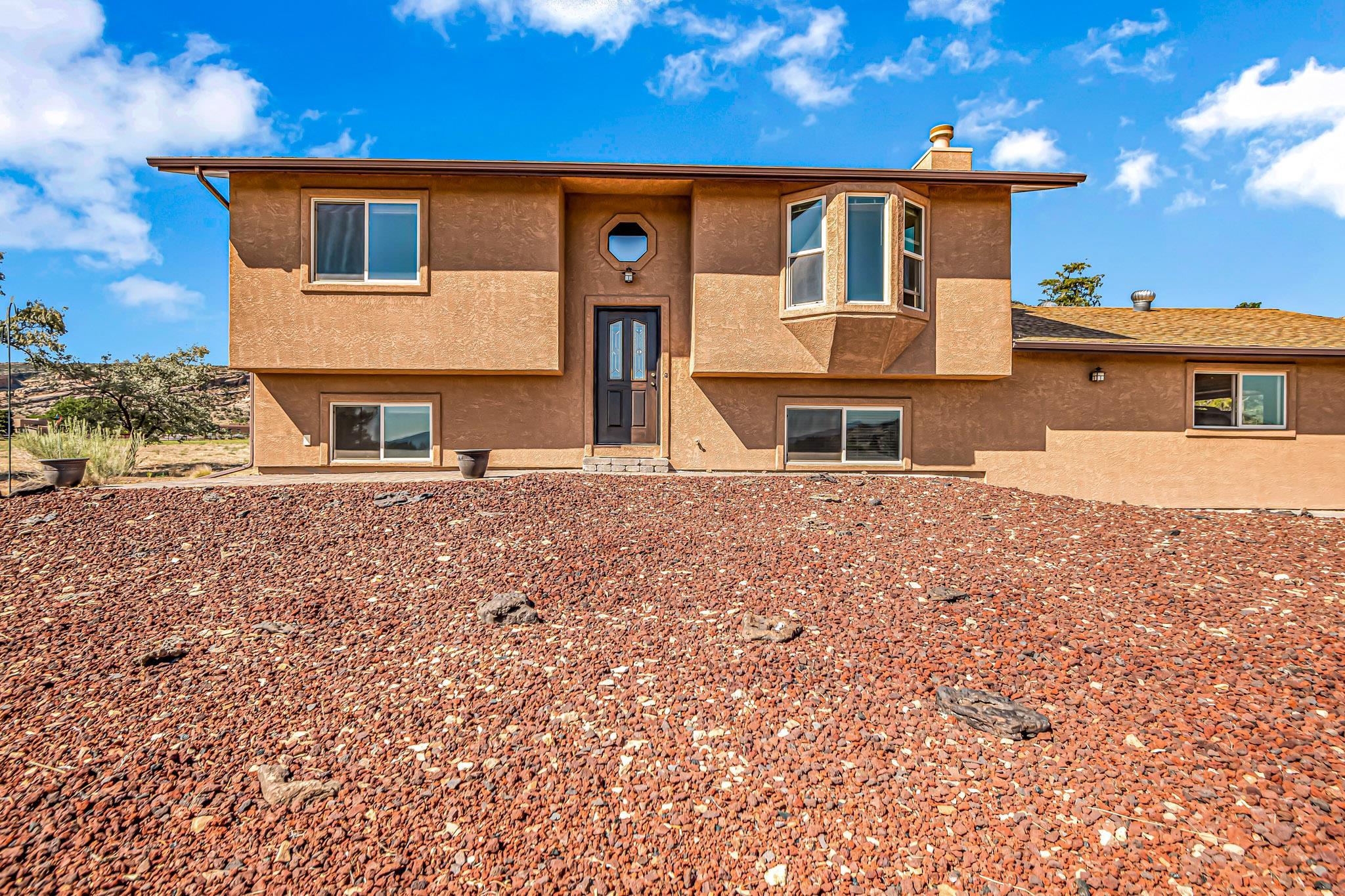 Location, Location, Location!!!! This one is in a great neighborhood with the most amazing 360 degree views! Very close to hiking trails, the Colorado National Monument east entrance, The Lunch Loop biking trails and minutes to downtown Grand Junction. Enjoy the Monument views from the covered south facing deck and the gorgeous colors on the Bookcliffs as the sun sets from your north facing patio. The landscape is natural desert plants and grasses and the wildlife sightings here are plentiful! The home has been lovingly cared for and features beautiful hardwood floors, newer windows, remodeled bathrooms and stucco. The lower level flex room and family room are combined and offer many possibilities for use and there is a gas stove for those chilly evenings. There is plenty of storage and the garage has 4 closets, 1 of which has a 220 outlet. RV parking allowed. You neeed to get inside this one! You won't be sorry!