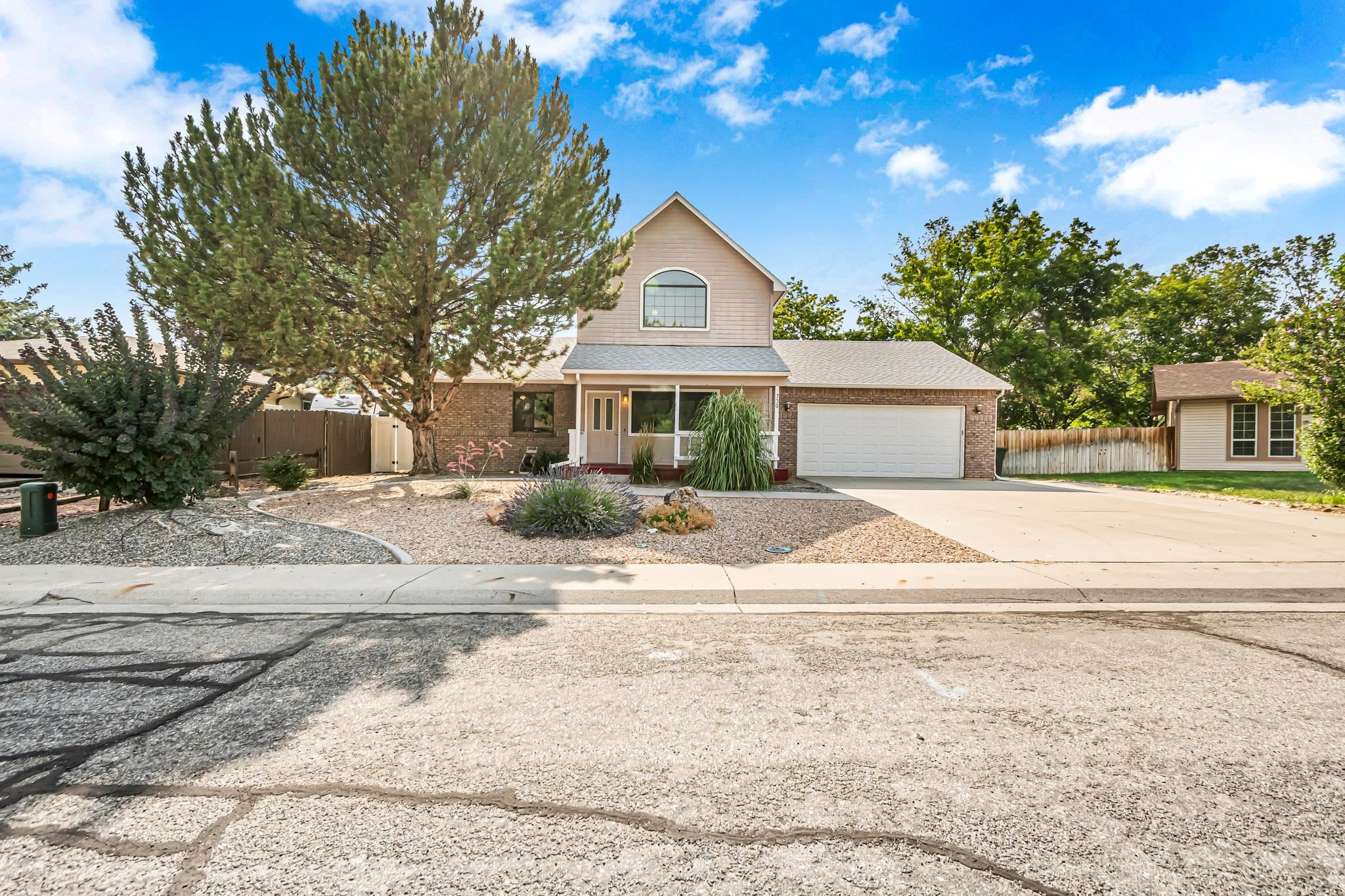 Welcome to this charming home in Fruita, Colorado! You will be welcomed with a freshly painted large covered front porch. Inside, the living room has high two-story ceilings, hardwood floors, and a dry bar. The kitchen, with its knotty pine cabinets, opens to both entertaining areas and a large dining area. The bright and spacious family/sun room is super cozy with warm knotty pine paneling and access to the backyard. The entire second floor is an expansive primary suite providing separation from the main level bedrooms. The most recent updates include a newer roof, boiler, evaporative cooler, hot tub, sprinklers, carpet and fresh paint. The backyard is a private oasis with a generous yard, mature shade trees, large patio and a hot tub. Located in a quiet cul-de-sac in a great neighborhood, this home is just a short walk from the Rec Center, Downtown, Farmers Market, and Fruita schools. Plus, you're only a short drive to awesome mountain biking and hiking trails. Enjoy all the outdoor fun that Fruita offers!