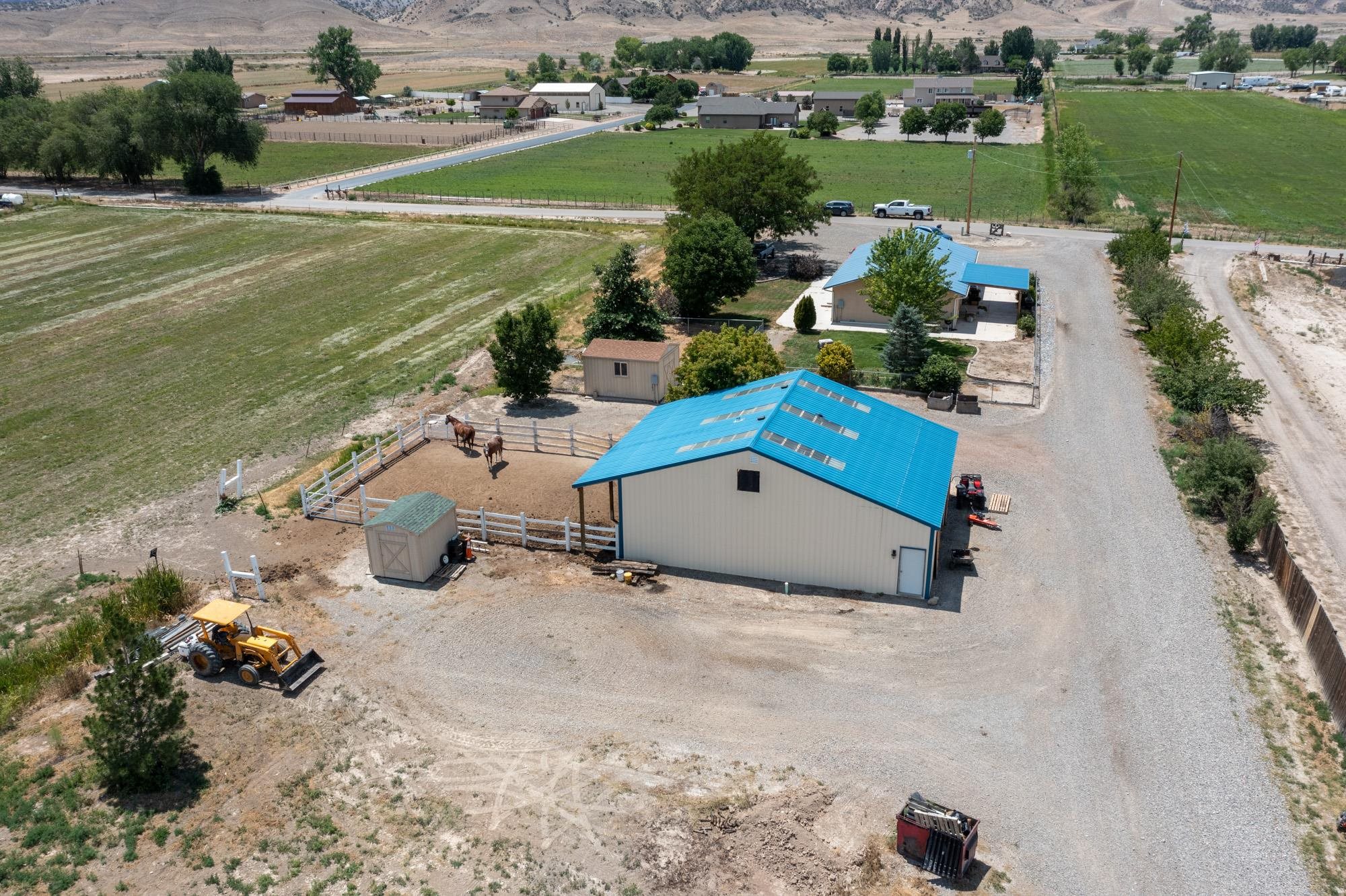 Site built, wood framed. Come experience homesteading at its finest. Bring your livestock, your RV's, boats and toys. No HOA. This property offers it all. 3 Bedrooms and 3 Bath wood framed site built Ranch. This cozy home offers air conditioning and on demand hot water heater. The kitchen has dark cabinets, island and granite countertops. Both primary bedroom and second bedroom have attached full bathrooms with closets. There is a full bathroom right off the third bedroom for your guests.  The three stall barn has 2 divided metal and wood doors to keep your animals comfortable in the winter with a 3rd door available. The Metal barn could also be used for storage of a motor home, boat or toys with water and electricity. There are 2 RV hookups on the property. The air conditioned 3 bedroom and 2 bath purged ADU is a great for income producing or a multi-generational home. The ADU has its own electricity, propane, septic and address. The property can be subdivided (according to owner) and has 2 entrances. The second entrance is on the south side of the adjacent property with the designated L 1/2 Road. The hay field of 9 acres is in grass hay with plenty of irrigation water. 14 shares of Grand Valley Irrigation water, which is included in the price of this property, will be conveyed at successful closing and funding. Fenced in yard surround the house for safety of your dogs. There is an additional fenced off area for your dogs when you have company.  A raised garden bed is near back patio with sprinklers.  Back patio has a wood burning fireplace to enjoy a drink with views in the evening or coffee in the morning. 2 sheds are included on the property for all of your storage needs. Large shed has electricity. Less than 10 minutes from Fruita, Adobe Creek National Golf Course and Kokopelli trailhead biking/hiking trails.