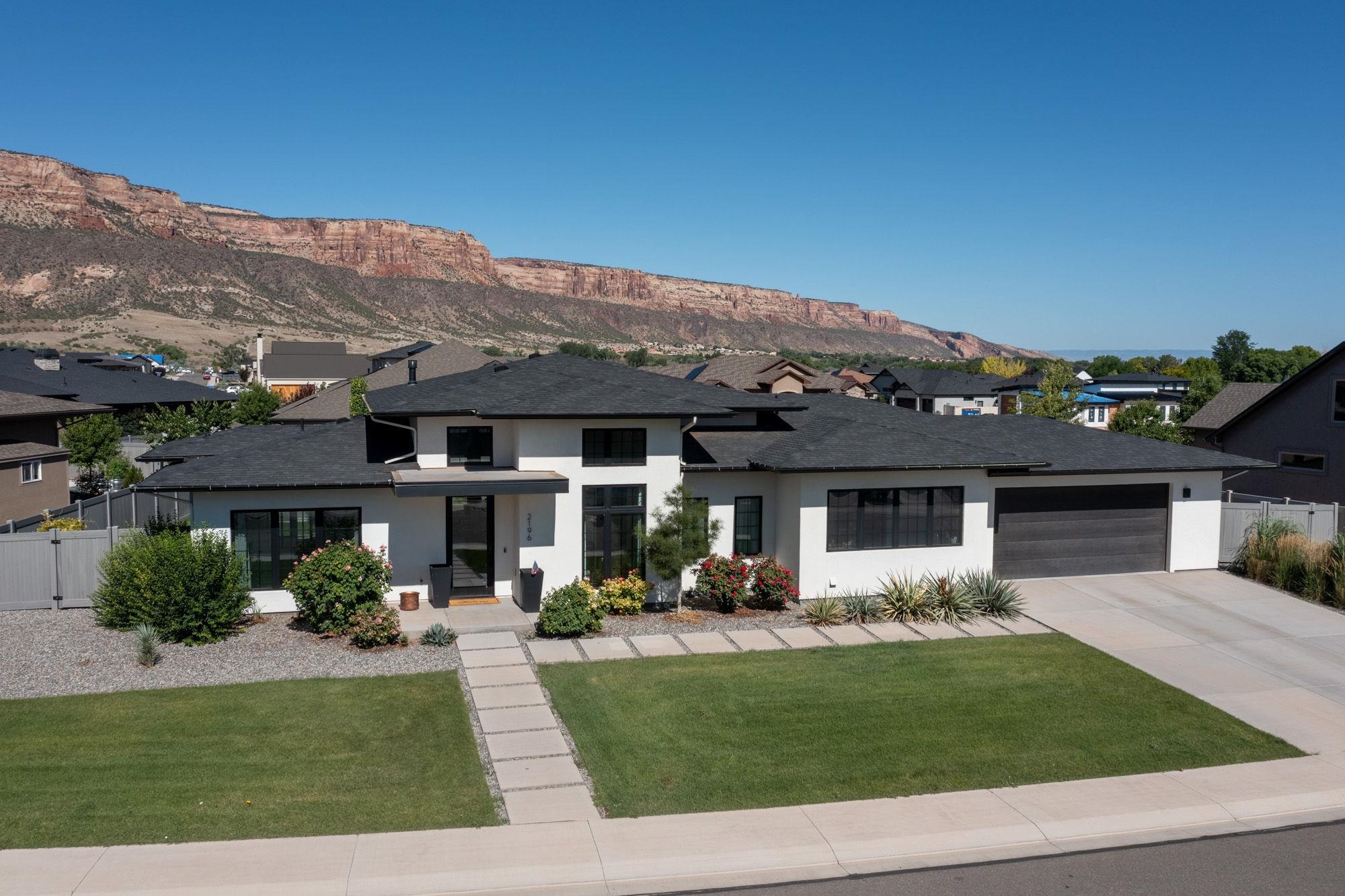 Discover this stunning ranch-style home in the sought-after Granite Falls neighborhood, custom-built by J. Howell Custom Home Builder. This 2019 Parade Of Homes HBA Judges Award Full Sweep Winner ($500,000 to $1 million category) and People's Choice Award recipient boasts incredible views of the Colorado National Monument from almost every room. The 2,324-square-foot home features a modern design with clean lines, black windows, and white stucco. The spacious great room, open to the eat-in kitchen, has a large window wall for Monument views. So don’t miss out on the opportunity to own this beautiful home!