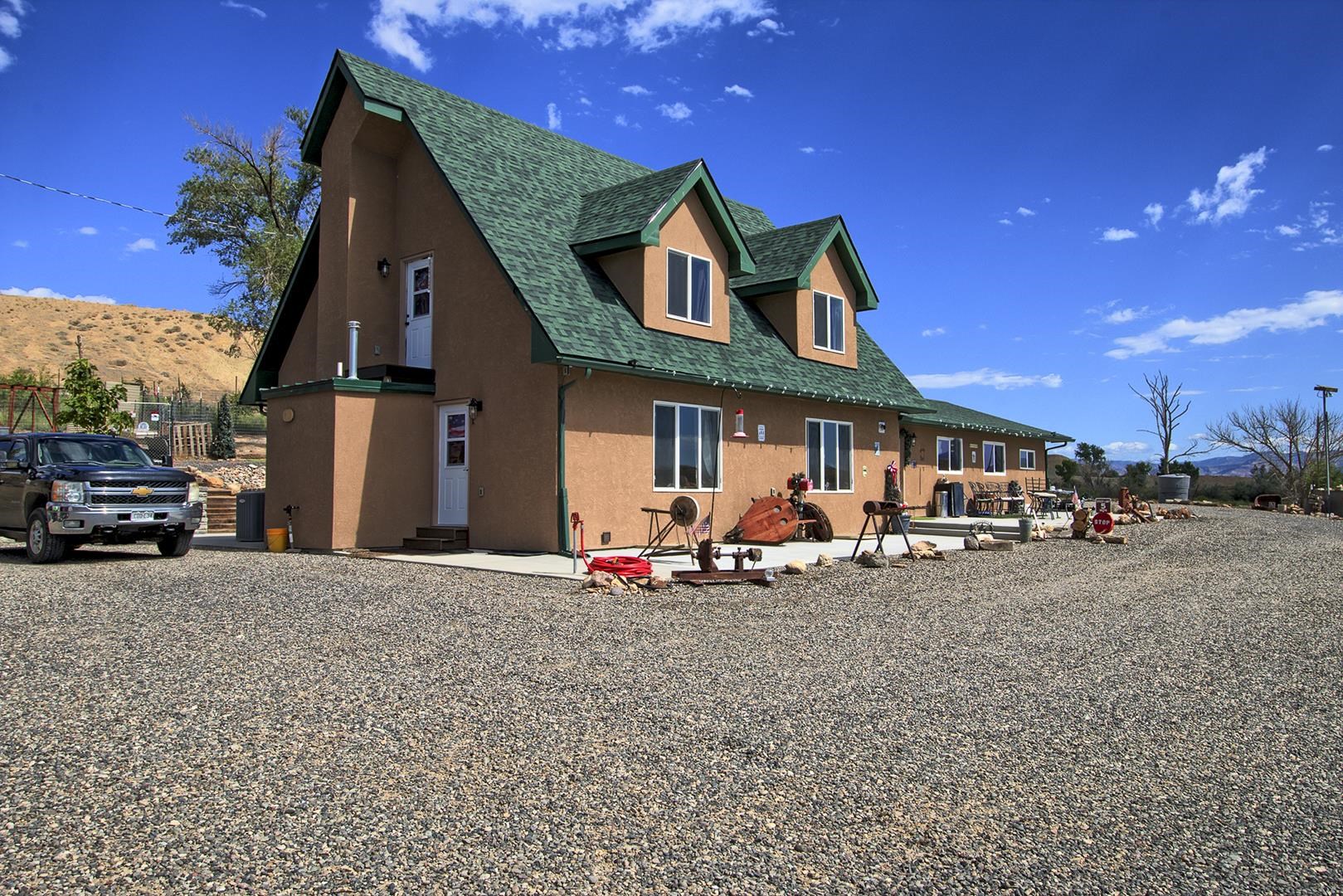 Quintessential Colorado large acreage property with 360 degree views.  This stunning property has been recently been remodeled and boasts beautiful upgrades. High end commercial appliances, open concept, special touches throughout and finished perfectly.  The Lower level can be accessed by a separate entrance and has a full kitchen making it the perfect in-law set up or income producing rental. There is a separate stand alone building with washer and dryer hookups, perfect for an art studio/office/creative space.  There are 5 full 30/50 Amp hook-up RV sites and 7 dry camping sites.  Enjoy walking around the irrigation fed pond, or hike through your own property to Mack Wash (river). 4000 square foot barn with plenty of storage space. You can truly have it all on this property, hiking, mountain biking, shooting range, agricultural use, cattle, horses, etc. This is a very special place.