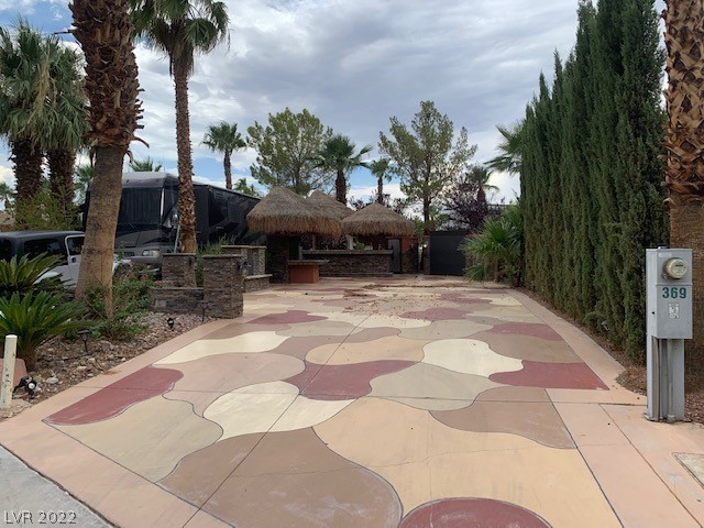 Located within the Class A Las Vegas Motorcoach Resort, this highly upgraded site featuring a large gourmet kitchen, granite counters, stone veneer, dining table w/tv niche, water feature, storage sheds, palapas, upgraded pad, and much more!  OWNER WILL CARRY!