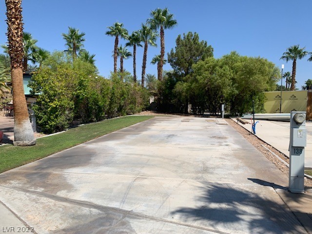 Located in the guard gated Las Vegas Motor Coach Resort, this fantastic site is right across from the clubhouse!!   This west facing site near the main clubhouse has tons of potential, a huge left side hedge row, grass, and mature trees in the back for privacy!