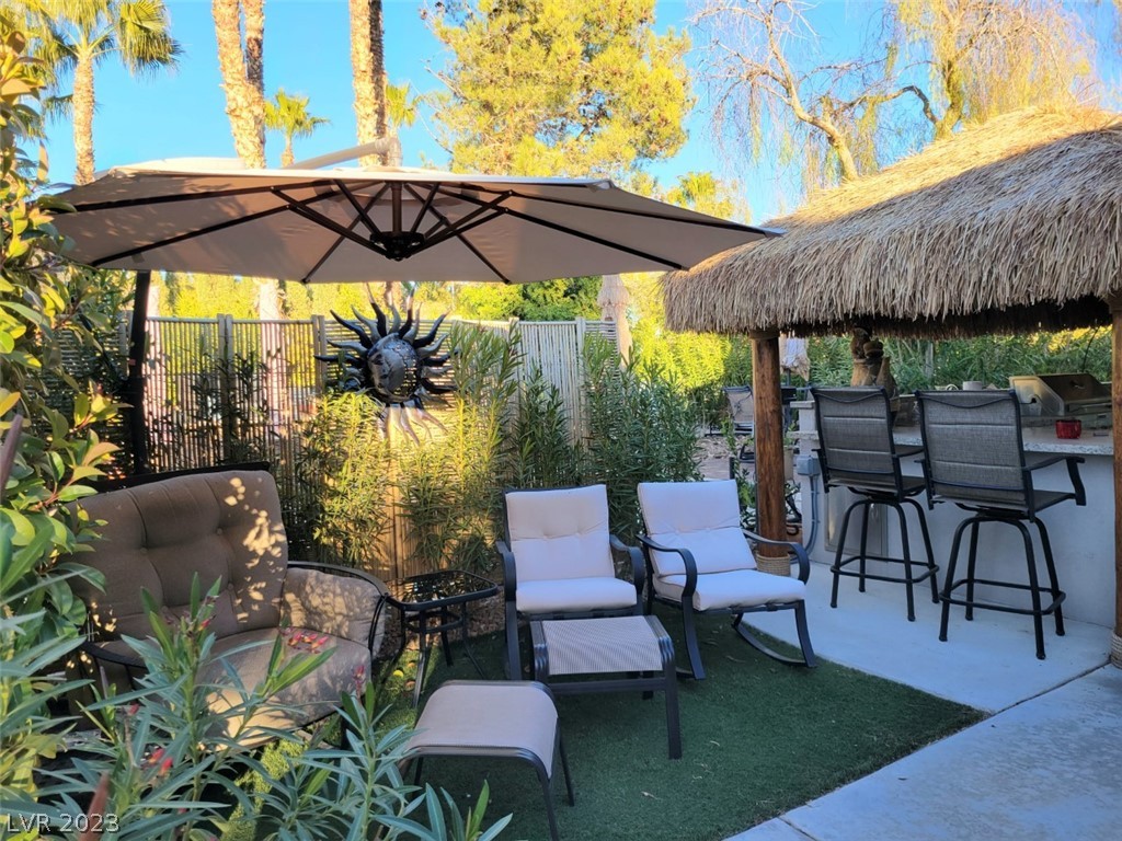 Located within the Class A Las Vegas Motorcoach Resort, this charming site has a nicely built out kitchen area with granite counter tops and bar top seating shaded by a brand new large palapa. There’s additional table seating shaded by privacy hedges and an umbrella. The back area of this site has been extended with synthetic grass to create a private lounge area to relax. What a great value!