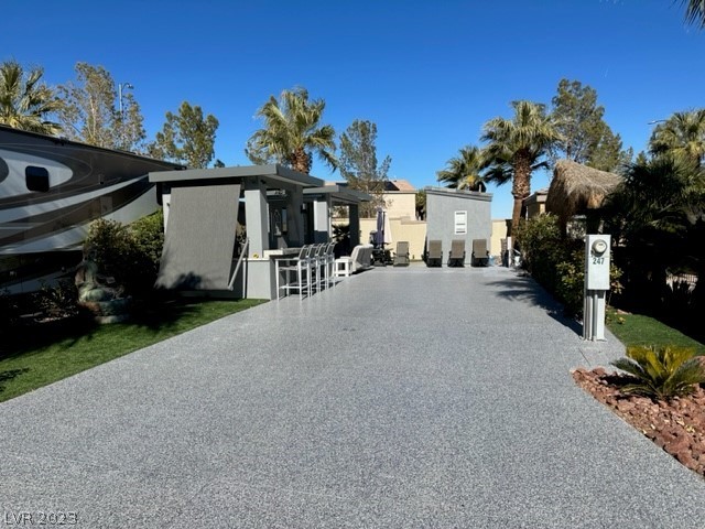 Located in the 24 hour guard gated Las Vegas Motor Coach Resort, this fantastic site has epoxy flooring and 3 hard roof structures with a spacious outdoor kitchen featuring a BBQ, side burner, sink, fridge, and Pizza Oven!  Toward the back of the site is a large living room with TV and fireplace, comfort station, and storage room!   This one won’t last!