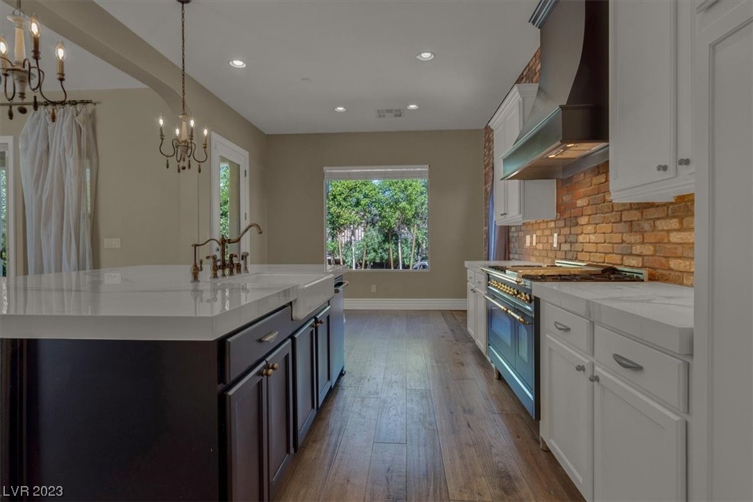 Large open concept kitchen with beautiful island, custom oven hood and