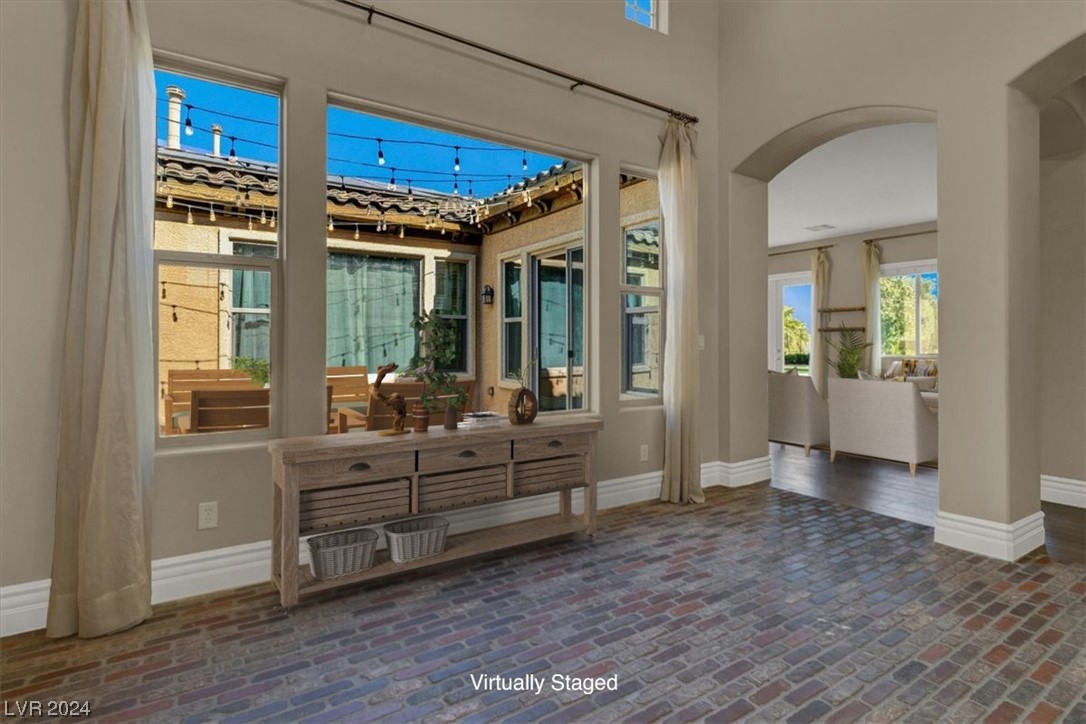 Enter to your homw with unique brick floors, and views into the home through the courtyard window