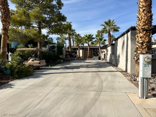 Located in the guard gated Las Vegas Motor Coach Resort, this cozy south facing site with golf cart parking has lots of privacy with an east side wall and left side lush landscaping.  At the rear of the site are decorative pavers which can be made into a gorgeous patio/dining area. OWNER WILL CARRY!