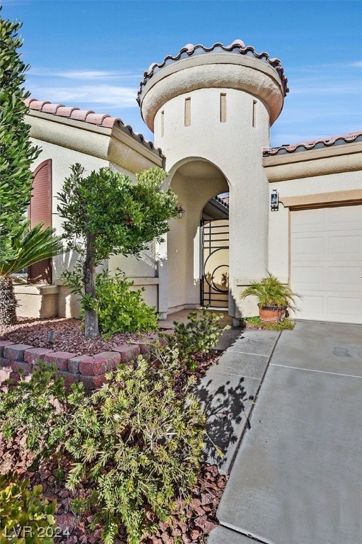 Beautiful gated courtyard entrance with custom wrought iron door provides security and privacy