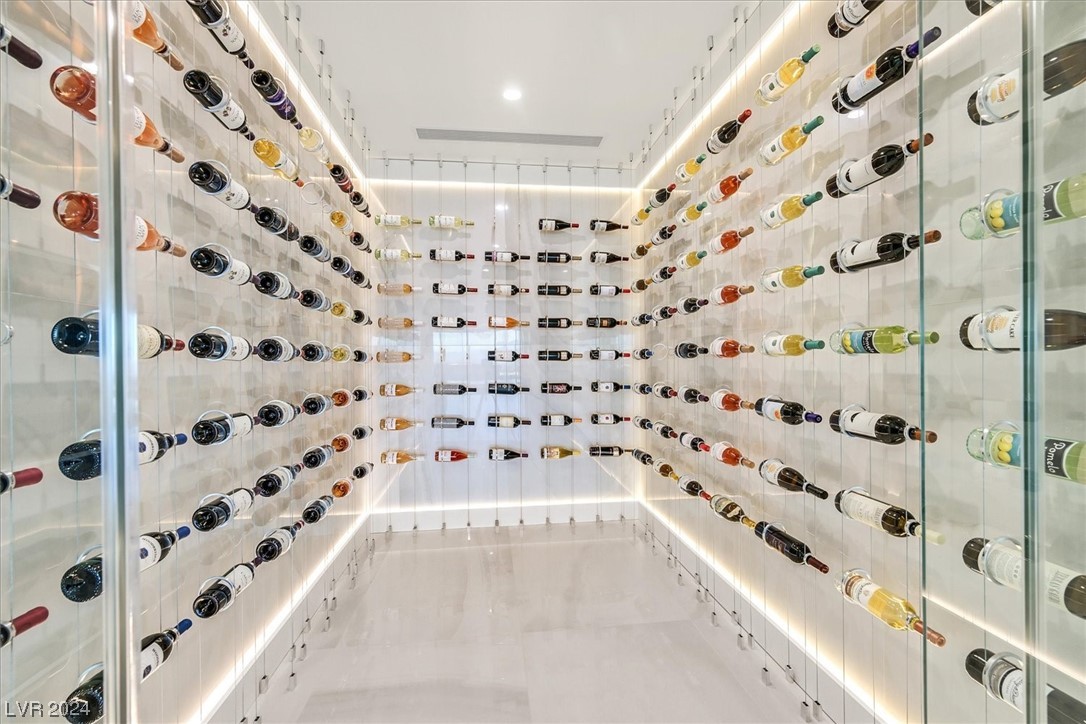 Custom designed cable supported climate controlled wine cellar holds approx. 200 bottles.