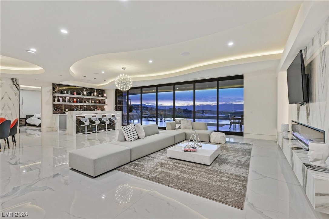 Downstairs great room with spectacular city and mountain views! Porcelain wall treatments and linear fireplace.