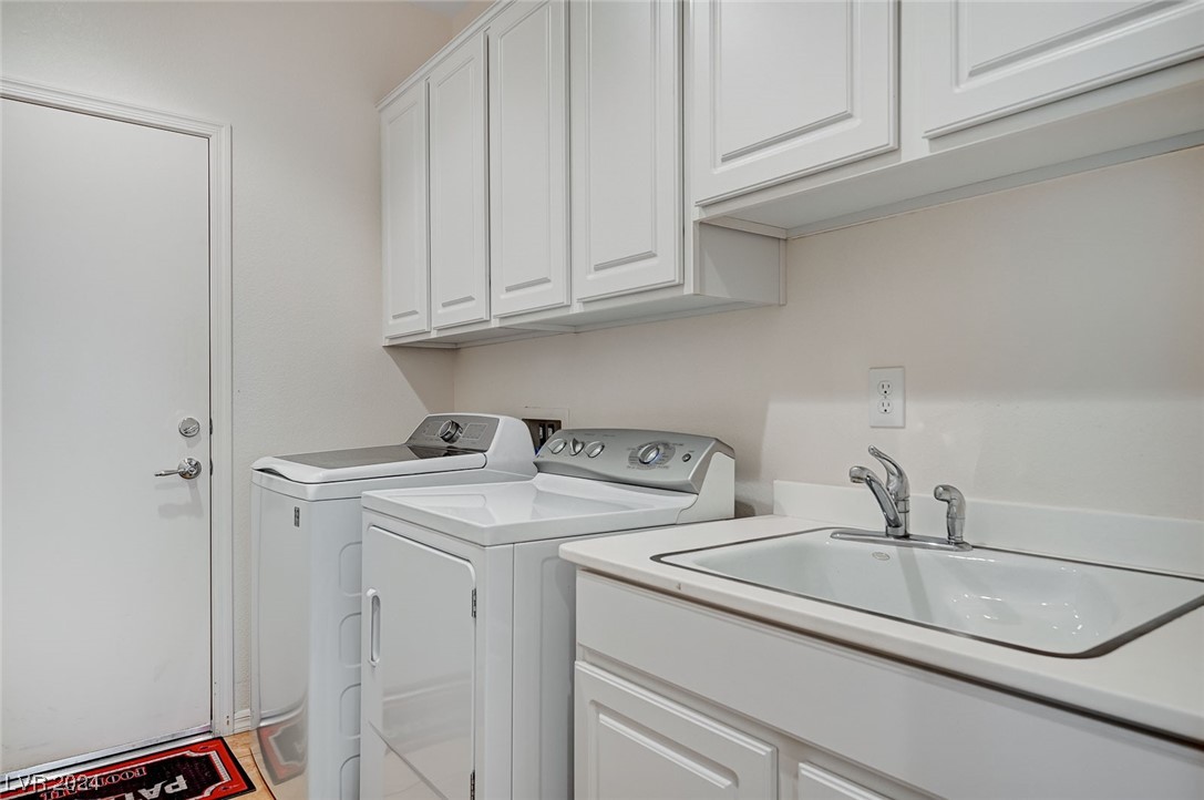 Huge laundry area with cabinets & sink