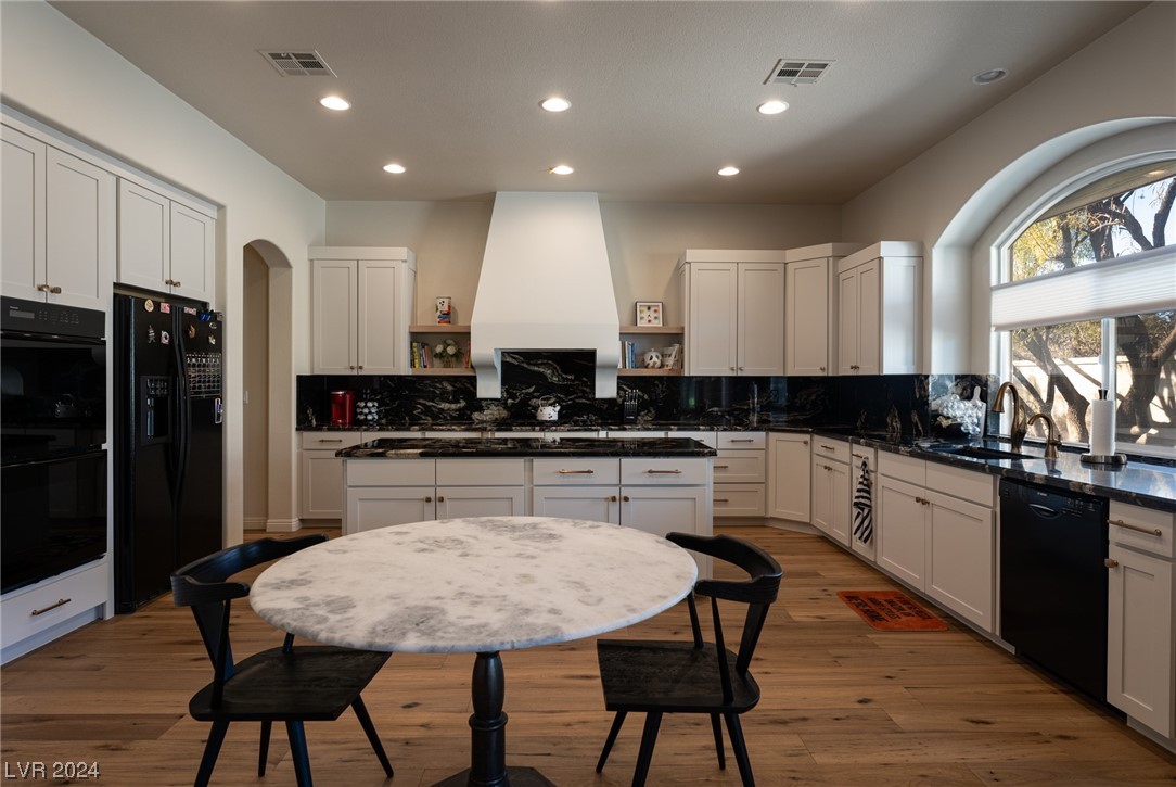 Gorgeous gourmet kitchen with custom cabinetry, black granite countertops and full backsplash